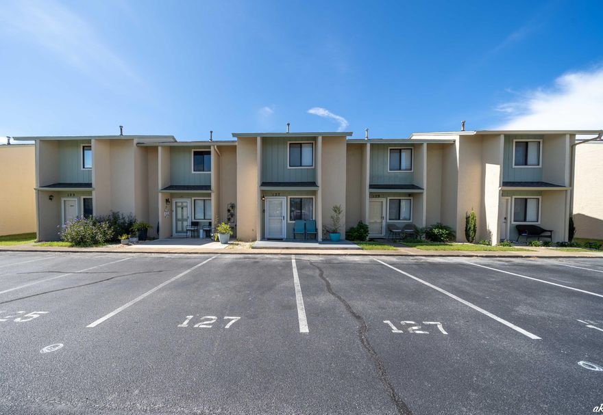 This is a turnkey, 2 bedroom adorable, furnished unit ready for you to have your beach home or a revenue producing property! This gated community has low HOA fees with plenty of activities on property and is centrally located to everything PCB has to offer including easy access to the beach, shopping and dining. Some of the amenities include a mini golf course, shuffleboard courts, tennis courts, a fitness center, a playground and 11 pools to enjoy including a gulf front pool!!! This updated unit provides an open floor plan with comfortable living space. Flooring has been recently replaced with scratch resistant, waterproof LVP in the main area and hardwood, stained and treated pine on the stairs..no sand in carpet, perfect for the beach!