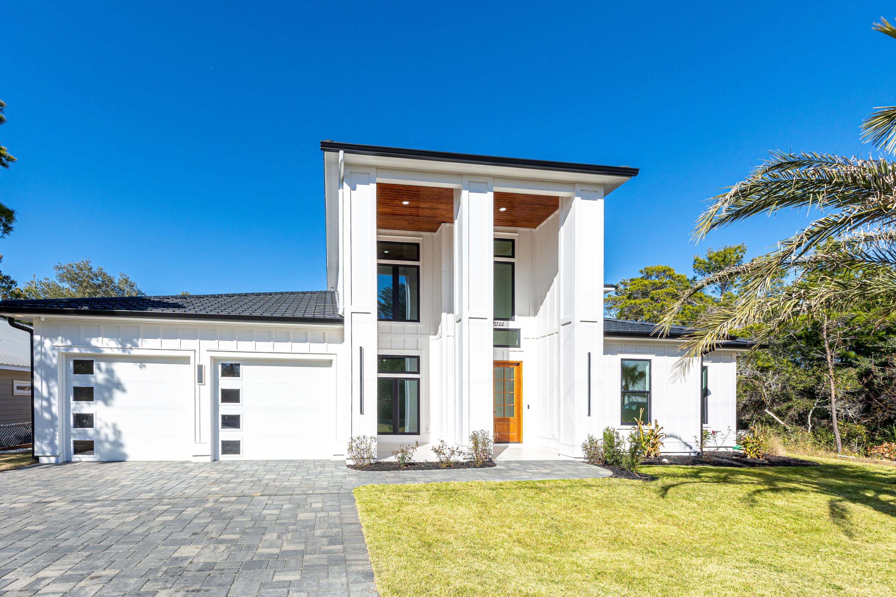 3400 SQUARE FOOT MODERN BEACH HOUSE ONE BLOCK OFF ICONIC 30A IN SANTA ROSA BEACH!! JUST A FEW MINUTES WALK TO THE BEACH!! MANY SHOPS AND RESTAURANTS LESS THAN 1/2 MILE WALK FROM YOUR NEW HOME! As you walk into this grand new home through the richness of the 8ft Mahogany double entry doors, your eyes are immediately drawn to the backyard and 3 level saltwater heated pool. The pool includes a spa level, sunbathing deck and finally the swimming level. It begs you to float your day away. The back yard is truly an oasis, boasting a fabulous entertaining area with a screened in lanai and a separate cabana offering a bathroom and outdoor kitchen with granite counters, natural gas grill, fridge, ice maker, TV hookup, and an outdoor shower to get the sand off when coming from the beach. This home is equipped with everything you need to entertain and have fun while outdoors! The lot size is larger than most you will find in the area and has room to play in the yard itself. The yard features artificial turf around the pool to reduce maintenance, as well as a paver/turf combination patio area leading to the pool and cabana. Enjoy all of these back yard amenities within the privacy fenced yard for the ultimate private backyard entertainment and relaxation space!! The screened in lanai off the back of the home as well as the 20 Ft tall grand entryway on the front are both tiled with 24x24 inch tiles maintaining sleek lines. The entry way shows off tongue and groove wood ceilings adding to the richness of the exterior. There is a Trex balcony across the back upper level of the home overlooking the pool, with the same tongue & groove wood ceilings, and french doors leading to the bedrooms and rec room inside.  Custom made rod and railing systems both on the interior and exterior balconies provide safety and add to the luxurious modern feel of the home. You will see touches of the Mahogany throughout the home, balcony, cabana and porches where tongue and groove ceilings are prevalent - it brings that beach house feel together while exuding luxury and modernness. Perfectly done for a home that is near the beach! More highlights of the exterior include the paver driveway with a grand cobblestone look in a rich slate color. The home has a 2 car garage, and the driveway can hold up to 6 more cars. The black metal tile Worthouse roof system is a standout - individual tiles can be replaced versus replacing the whole roof, and the Worthouse system offers a 30 year warranty. The impressive interior of the home is tiled with wood plank tile throughout - 10x60 inch rectified planks to limit the amount of grout needed, for a more seamless look with low maintenance. All interior doors are 8 foot tall solid wood, and the ceilings are 10 feet upstairs and down. The main living space is a wide open concept with family room, dining space and kitchen all overlooking the pool outside. The family room is equipped with built in speakers for surround sound, and a fireplace to add a little more ambience at night. The family room accesses the pool by triple stacking slider doors into the screened in lanai. The Chef's Kitchen is equipped with top of the line stainless steel appliances such as a Wolf Pro Series wall oven and additional Pro Series steamer/convection oven, along with a professional five burner stovetop by Wolf. All other appliances by KitchenAid including an undercabinet microwave oven drawer. The striking cabinetry goes all the way to the ceiling with LED cabinet lighting and glass doors up top. The hand picked quartzite kitchen countertops continue seamlessly all the way up the 10ft kitchen walls as the back splash, and the quartzite waterfall feature on the kitchen island creates a dramatic look. The walk-in pantry has coordinating custom cabinetry and lighting as well as quartz countertops, keeping the kitchen free of small appliances and creating extra easy-access storage. The dining space features a wet bar/coffee bar with a KitchenAid wine fridge, and buffet space. The large first floor primary bedroom leads to its own entrance to the lanai and pool via French doors. This primary bedroom has a fireplace and walk-in closet with custom built-in shelving/cabinetry system. The primary en-suite bathroom features a deep stand alone tub, separate shower with body sprays, floating double vanity with quartz countertops, a cosmetic area, and under cabinet LED lighting. The water closet is equipped with a Smart Bidet with motion sensor feature, which detects your presence and activates the bidet when you open the door. There is a guest bedroom with en-suite guest bathroom on the first floor, as well as a dedicated private office off the foyer, tucked away from the core open concept area. The laundry room has more cabinetry and quartz countertops for more storage, as well as a sink basin, and features LG large capacity washer and dryer. There is also a powder room downstairs for guests. Upstairs you will find a roomy rec space with fireplace and tongue & groove wood tray ceilings. There are two guest bedrooms upstairs both with en-suite bathrooms, as well as a flex room that could be used as a media or exercise space, or a bunk room. All full bathrooms in the whole home feature spectacular hand picked custom tile work on the bathroom walls. All bedrooms are prewired for mounted TV's. The home also comes with a well and irrigation system for the sodded areas of the yard, as well as a whole home central vacuum system. To speak on the home's location, the West End of 30A, you will find a little less hustle & bustle, and a little more chill beachy vibe. This is a beach walker's paradise! Join the many walkers and bike riders enjoying the scenery of West end 30A both beach and beyond - visit all the popular shops and eateries such as shopping at Gulf Place, and restaurants such as Shunk Gulley, Stinky's Fish Camp, Mimmo's Italian Eatery, Redfish Taco, Cowgirl Kitchen, Blue Mountain Bakery and so many more. Grab a beer at Growler Garage, or a cone at Pecan Jacks! Stop in Goatfeathers for their lunch special raw oysters! Or pick up some seafood to cook at home at the Goatfeathers Seafood Market right around the corner from the house! If you're looking for a little adventure in nature you can hit the Longleaf Pine Trail Head right here in the neighborhood! Whether you are looking for a "Chill in your own back yard oasis" primary home, or a stunner vacation home that has you relaxed as you walk in the door, or a rental investment home that attracts like a rental machine should, this home will not disappoint! Please contact me for your private tour of this outstanding residence today!! All information contained in this listing is deemed to be accurate but not guaranteed - Buyer must verify all information.