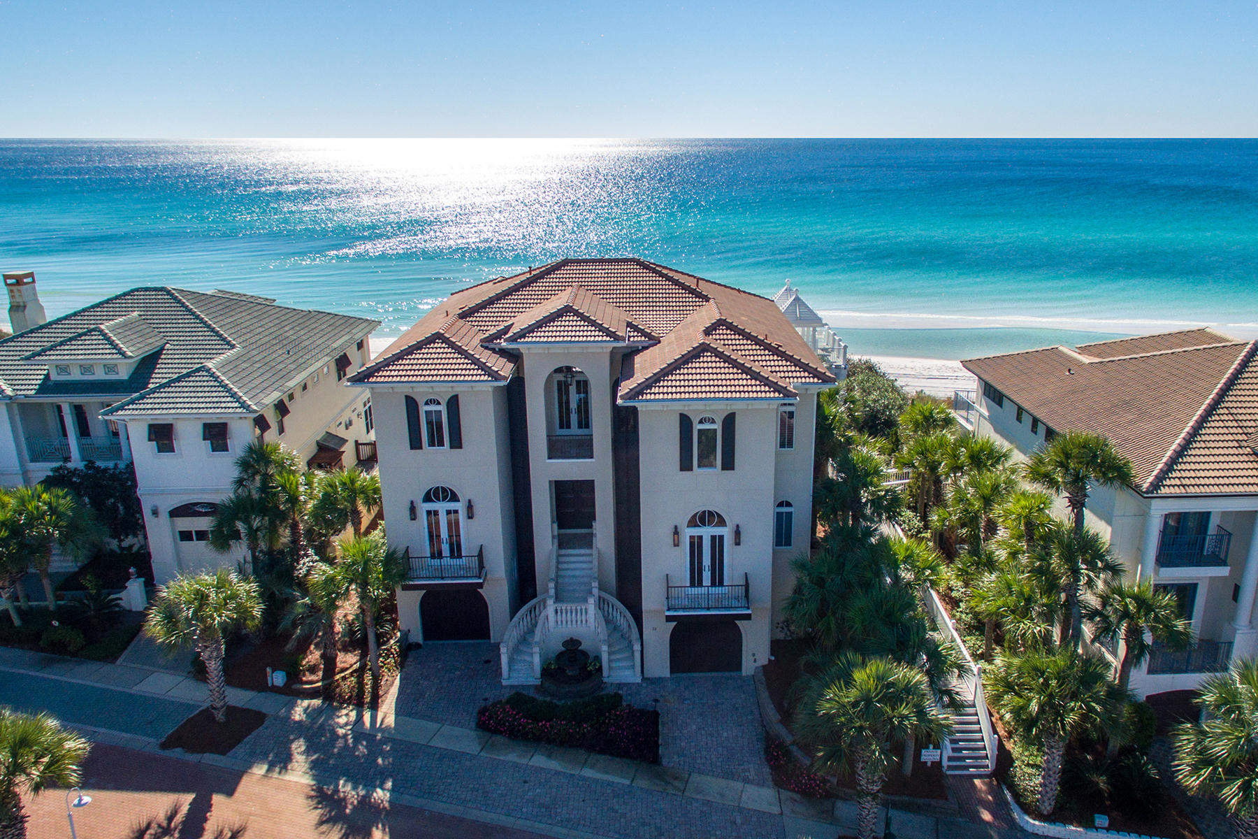 This one-of-a-kind home enjoys a prime gulf front position within the gated Village of White Cliffs community. Recently redesigned and redecorated with no expense spared, this three-story home is among the highest elevations along the Gulf Coast and takes advantage of the expansive gulf views Protected by a contiguous seawall buried in the sand dunes, this home is an architectural showcase with Anderson windows, marble staircase, twisted columns, as well as barrel, dome, and groin vault ceilings providing an aura of upscale design throughout this magnificent residence. The new owner can enjoy all the trappings of a luxury lifestyle with custom theater, game room and guest suite nestled into the dunes. The great room with 12 foot coffered ceilings offers two seating areas, gas fireplace