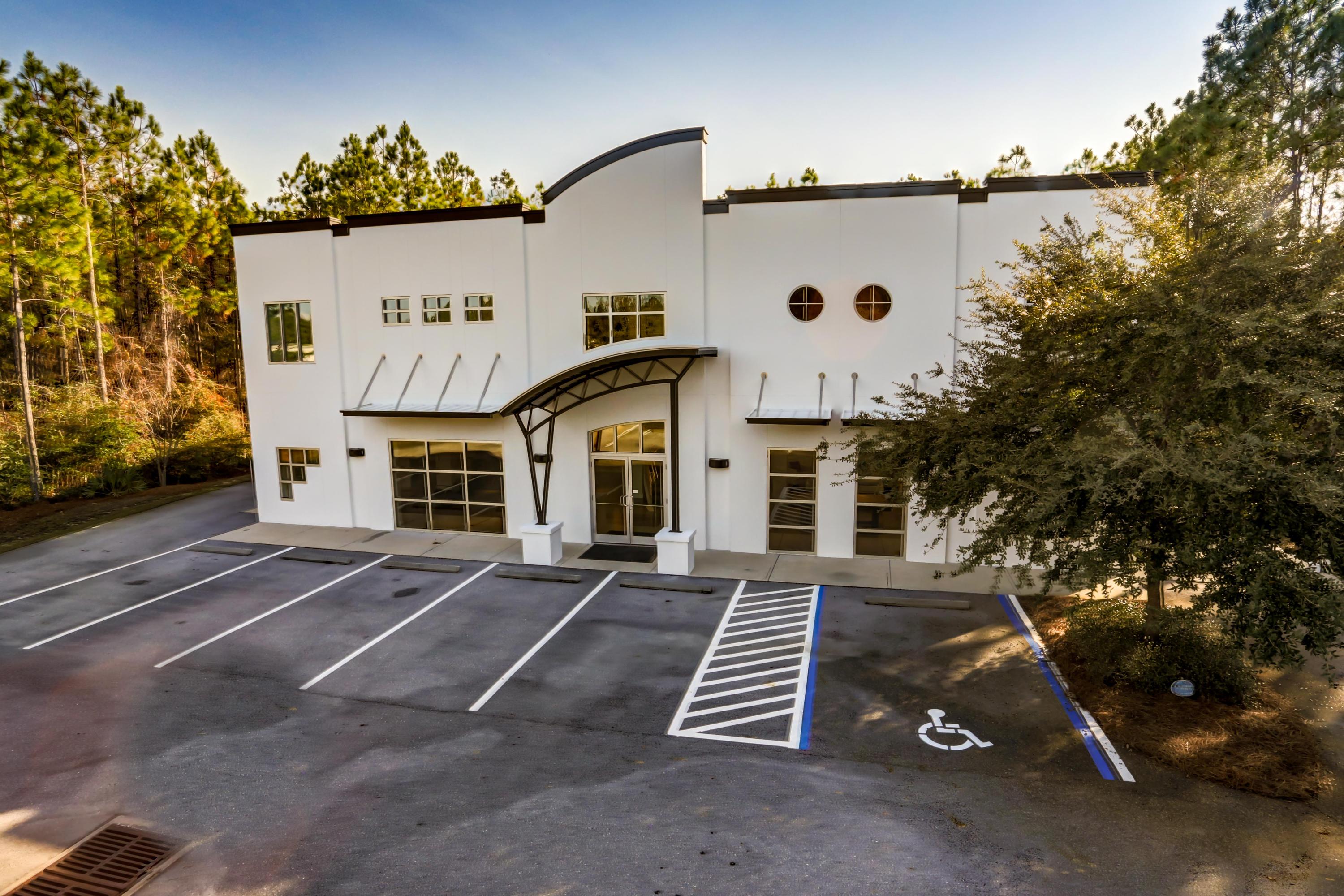 Exceptional +/-10,000 SF Showroom, Office, Warehouse, and Flex space situated on approximately .71 acres in St. Joe's South Walton Commerce Park and located in the South Walton County market of Northwest Florida. This premier site is well positioned logistically to Okaloosa, Walton, and Bay Counties, serviced by Interstate 10, approximately 25 miles to the Northwest Florida Beaches International Airport (ECP), 27 miles to Destin, and 74 miles to Pensacola.Containing a poured cell block exterior with a reinforced metal building and fortified roof system, the structural nature of this improvement is quite impressive. While the exterior projects modernized architectural elements, the interior finishes are commensurate and consistent throughout...