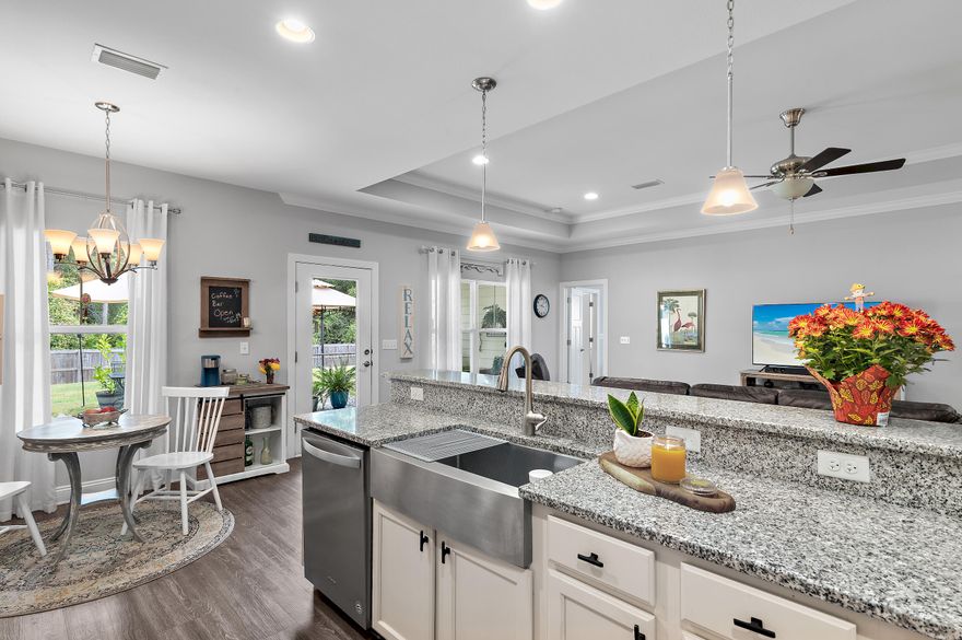 This immaculate 3BR/2BA Halifax home, built in 2018, feels brand new and has been meticulously maintained. Nestled on a private .28-acre fenced lot, it offers one of the largest and most unique backyards in Freeport; a true retreat for outdoor living. Inside, the open split floor plan flows seamlessly into the upgraded kitchen, pantry, with granite countertops, while the family room impresses with a tray ceiling and crown molding. The large master suite provides a peaceful escape with his & her closets and a tub and walk-in tile shower. Luxury vinyl plank flooring runs throughout, and a covered rear porch expands your living space outdoors. Conveniently located near schools, shopping. Walk to the Community pool and playground.