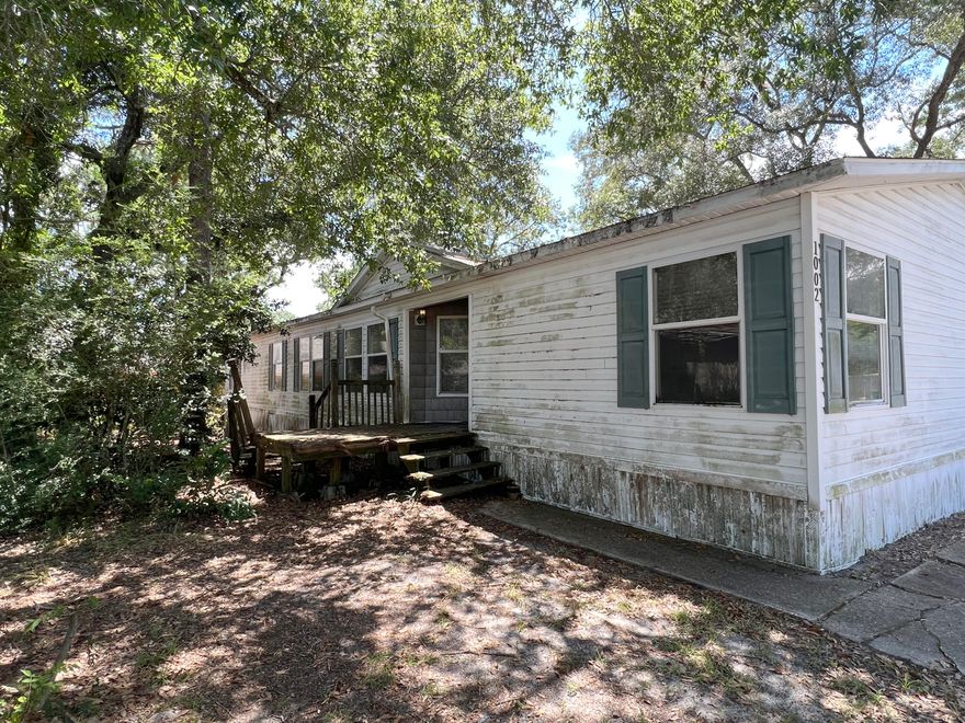 Built in 2002, located in the heart of Niceville, and close to everything, this double wide REO mobile home is one to consider. Located in a Mobile Home community with community pool, this split bedroom designed 4 bedroom 2 bath home has vaulted ceilings, a fireplace, large kitchen with island, living room, family room and dining room space. At 1844sf, this home would make a great investment or first home with the right upgrades and repairs. Due to home's condition, this property will not qualify for most types of financing. Call for details!