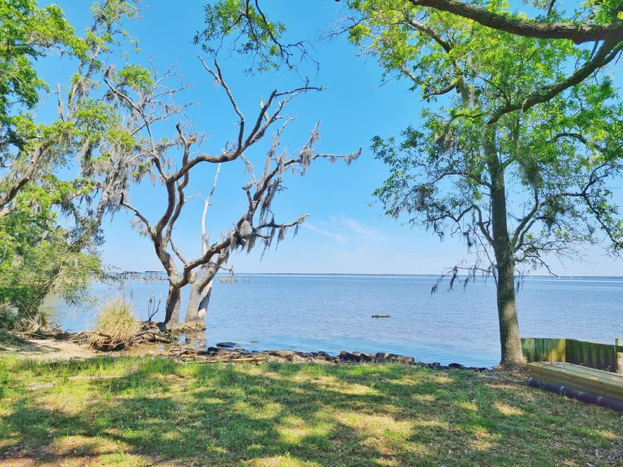 This  is a rare opportunity to own a 5+ acre property that kisses the bay in the north east corner. Majestic Oaks, Pines and Southern Magnolias dot the property throughout. Property could be used for one estate size spectacular homesite overlooking the water, or work with the county to further develop.  Underground power is at the property. To the south of this property is the Kellogg Nature Center with parking and trail to the Kellogg Bay front Park. To see the property in person, 24 hour advanced notice required to view the property. Owners live at the property. Call your agent to schedule a time to see the property in person. NO DRIVE BYs.