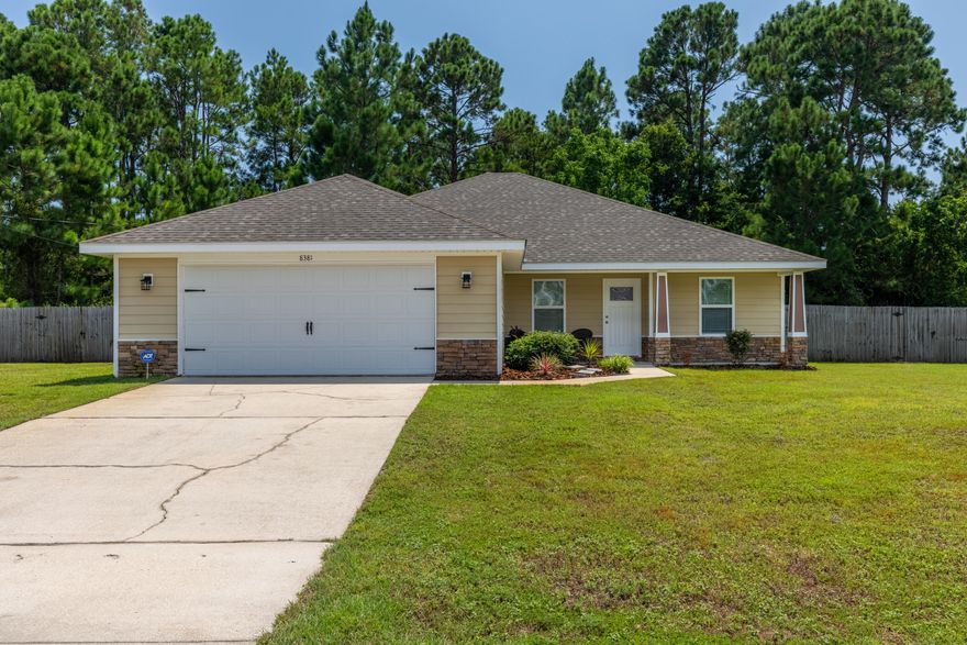 Located in East Navarre this 3bed/2bath split floor plan home is fully fenced with a huge back yard and gate access for storage, oversized garage and just minutes from the beach. Home offers great curb appeal with covered front porch with stacked stone accents and craftsman columns. Entering the home you will appreciate the open flow to the great family room, dining area and wonderful kitchen, lots of cabinet space and new granite countertops throughout.(Not photographed)  breakfast bar, beautiful backsplash and stainless steel appliances. The master suite has double vanities, walk in shower and large tub. There is a door that leads to the back patio. Huge utility room which opens to the oversized garage.