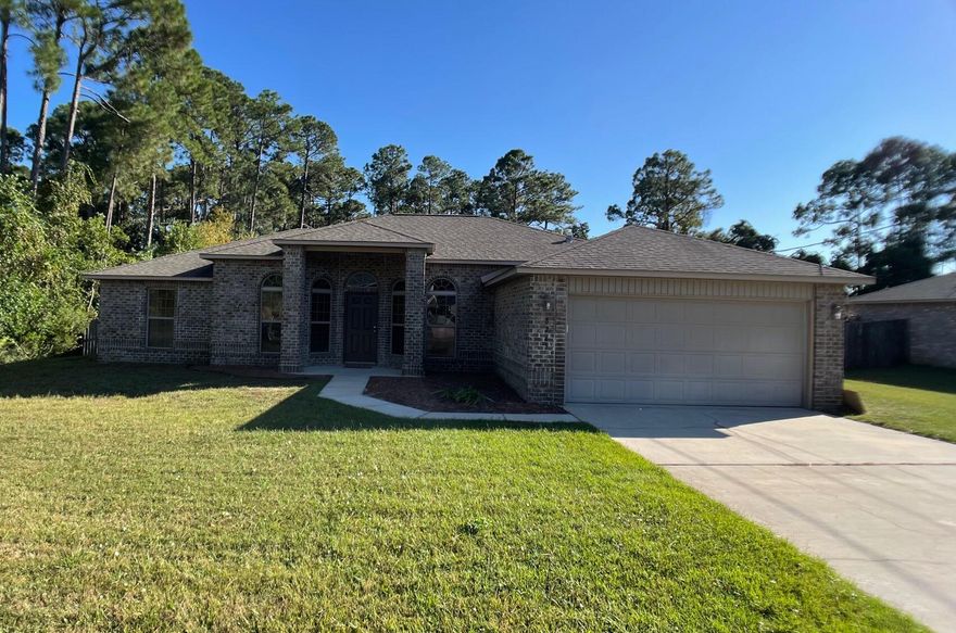 Spacious 4 bedroom home that includes an eat-in kitchen and large dining room that is a true bonus room within this open concept home. The split plan also includes a 4th bedroom with 10 ft ceilings that could be a luxurious home office, gym or guest bedroom. Covered back porch also has an attached uncovered patio that extends the space for entertaining in a large fenced backyard that includes tree-lined privacy all along the back and east side. Location is phenomenal with .5 mile access to Hwy 87 and Hwy 98. Grocery stores and restaurants nearby. Fast access to the Emerald Coast beaches and the Santa Rosa Sound. Be sure the home you choose has a proper sewer removal system. This one does! Well maintained, this home has a new grinder pump (3 yr warranty, $3200 value).
