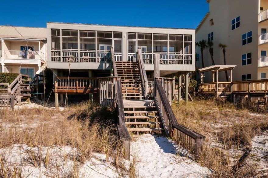 This unique gulf front Duplex in Crystal Beach with 60' of premium gulf frontage is a rare opportunity to own an authentic, Old Florida property that has been lovingly maintained by its owners for more than two generations. This two-story property is designed around an open living space with fully equipped kitchen and floor-to-ceiling windows that invite stunning views inside or out on the private screened porch. The upstairs loft includes a king bed & full bath with tub, and downstairs bunk room has twin beds and full bath with shower. Both units are identical. Other highlights include ample exterior parking, secure storage for beach equipment and outdoor shower. Great for vacation rentals, it generates around $80,000 in rental income with many owner stays. No association fees or H.O.A
