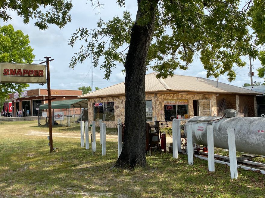 Corner Traffic Light! Florida DOT reports 43,500 daily trips at this intersection. Location Supreme! This is in the center of town at the south end of Main Street, three street access! Retail Commercial building in great location right in the middle of town! Block building has a showroom and firewall shop with a 1/2 bath. Central heat and air, metal roof, lots of under roof outside storage. Great place for a drive through restaurant, auto shop, or small engine repair. This is currently being used as a repair shop for small engine repair. Shop has 1 bay, a lean to for service/repair, and covered storage. Outdoor Power Business, Goodwill & Inventory to be listed. Price negotiable.