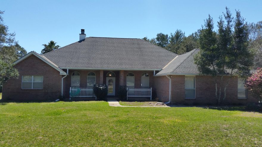 Beautiful, custom built, brick home sits on huge lot across from golf course and has private, wooded rear yard. Neighborhood offers fantastic amenities: 2 pools, 8 clay tennis courts, boat launch, fishing pier, baseball, basketball, gym, RV campsite and beach house rental. Nice floor plan with 3 bedrooms and an office or could be 4th bedroom. Huge family room with vaulted ceiling and pretty double sided fireplace that opens to office. Kitchen with good cabinet and work space has solid surface counters, smooth top stove, pantry and breakfast bar. Master suite is huge with tray ceiling and french doors to screened lanai. Master bath boasts 2 large walk-in closets, dual vanities, jetted garden tub, separate shower and toilet room.