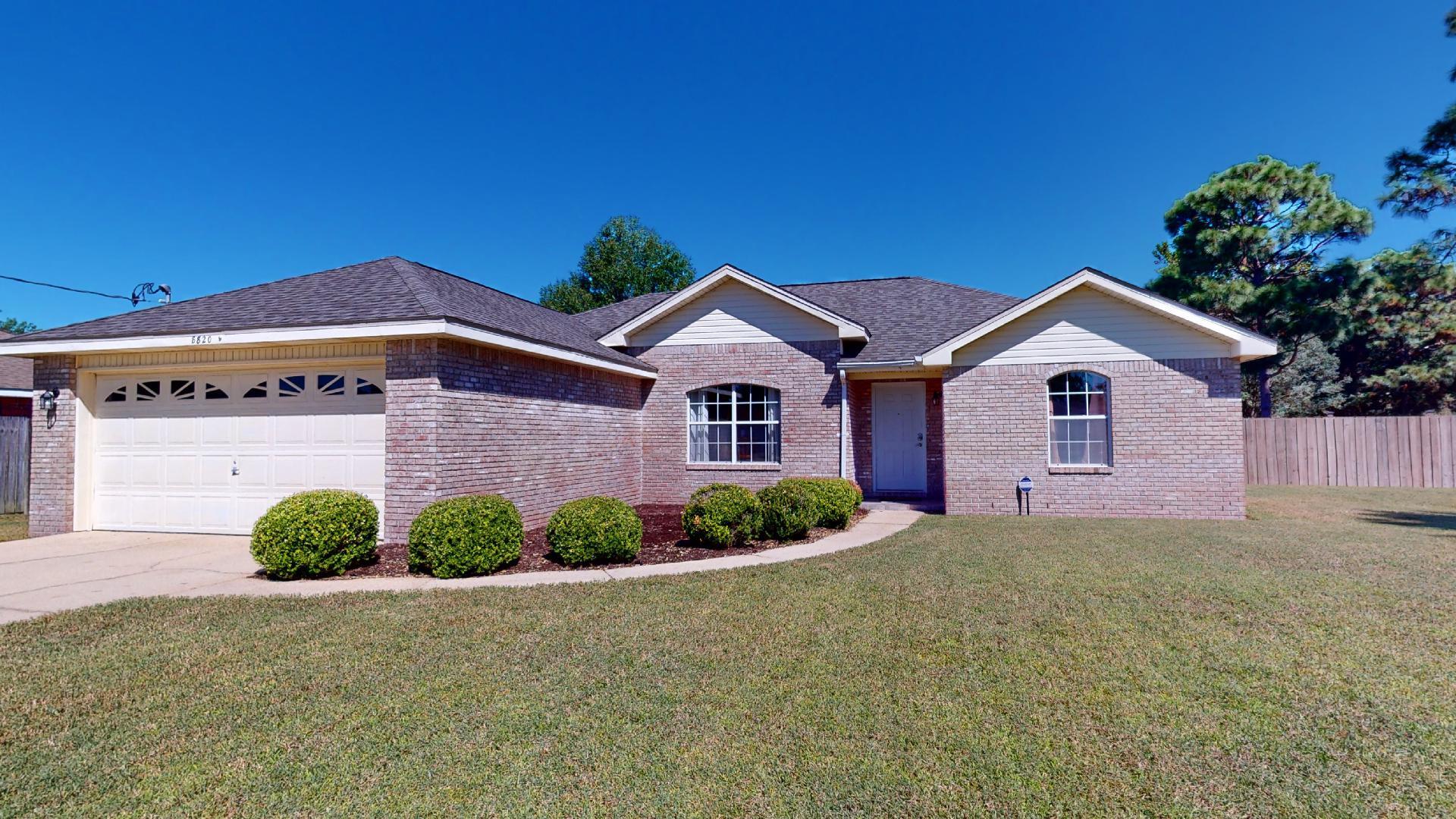 Beautiful all brick home, with new Roof situated on almost 1/2 acre in East Navarre. This home offers 3 bedrooms, 2 baths with popular split floor plan design. The kitchen has tile counter tops along with backsplash, no carpet in this home. Living room has a wood burning fireplace for those cozy winter evenings. French doors leading to the covered patio where you can enjoy sitting in the morning or evenings, big back yard with privacy fence and shed for extra storage, sprinkler system w/lawn pump. Both bathrooms have new vanities. Newer HVAC and Hot Water Heater(Less than 10 years old). This home is close to Navarre Youth Sports Association, Navarre High School, YMCA , Beaches and shopping. Call for you appointment today.