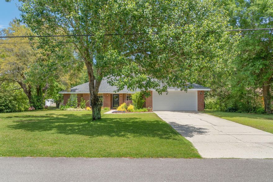 Beautifully updated family home in Holley By The Sea.  This 4 bedroom, 2 bath home is located on a low-traffic street, yet convenient to your Hwy 98 commute.  Walk in to a large living room with vaulted ceilings, fireplace, and a view of the back yard.  Enjoy the spacious and completely renovated kitchen boasting maple cabinets, quartz countertops, and black stainless steel appliances.  The large Master Bedroom has a large en suite bathroom with his/hers closets and updated double vanity, mirror, and light fixtures.  Enjoy the outdoors with beautiful live oak trees, new landscaping, and fire pit.  This property is High and Dry!  NEW ROOF November 2021, new AC 2020.  2 minutes from the HBTS Recreation Center offering swimming pools, tennis and basketball courts, gym, and more!