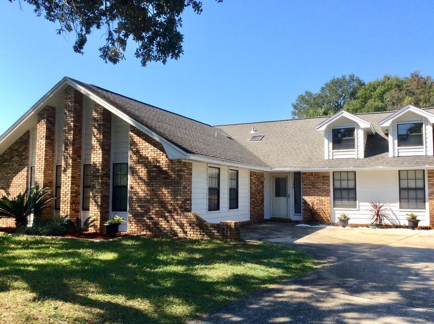 Super home ready for new owners in Mary Esther FL. Situated in a cul de sac with no through traffic this home offers 5 bedrooms and an easy commute to Hurlburt Field, the mall, restaurants and schools. There's room for everyone. The living room has a high cathedral ceiling and soaring brick fireplace. The remodeled kitchen offers updated cabinets, pantry, center island and adjoining dining area. French doors lead out to the fenced back yard and huge deck. New carpet in bedrooms and hall Oct 2018. Master. bedroom. has wood/laminate flooring. Two bedrooms have sinks installed, (European style), with Jack and Jill commode and shower. Teen retreat or mother in law suite! New HVAC installed July 2018. Come and take a look, and make this home yours.