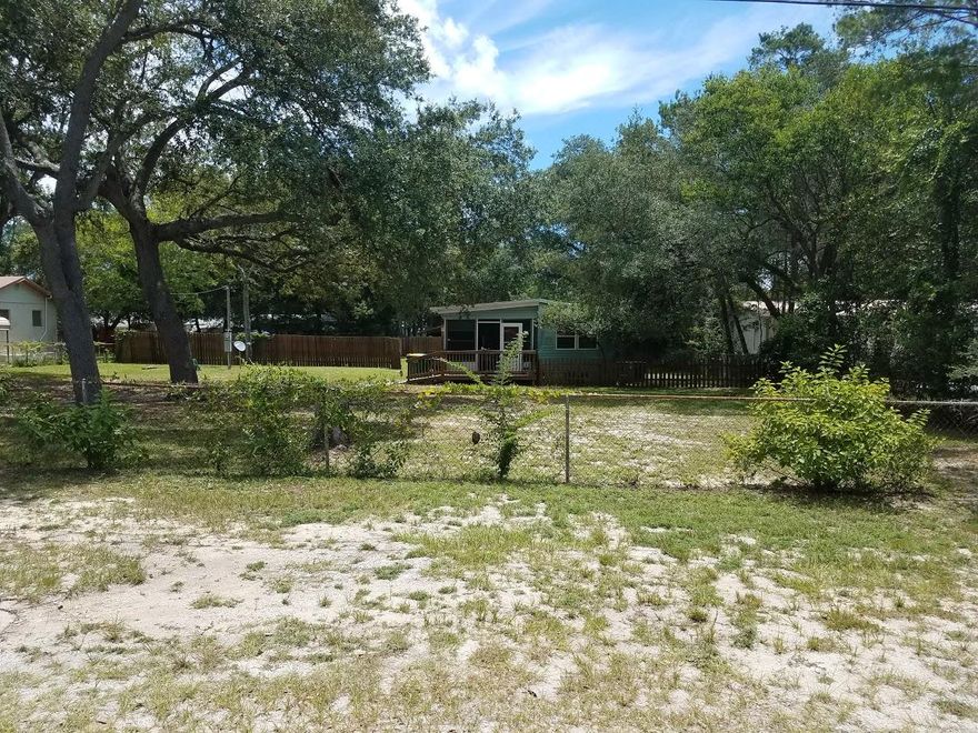SPACIOUS PROPERTY IN FORT WALTON BEACH!! Wonderful opportunity to build on this large lot or make the cozy 3 bedroom, 1 bath property your own! With a screened in front porch and a screened in patio in the back yard, it boasts plenty of space to stretch out! This location is close to schools and short drive to Wal-Mart, Sam's and Lowe's.