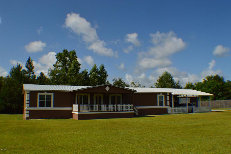 Beautiful 3 bedroom/3 full bath home on 2.57 acres on paved road in a desirable Falling Waters area! This home is a MH on paper only .. the exterior is stucco with a large covered front porch, new roof, oversized carport, and gravel drive. The interior is tastefully painted with earth tones throughout, walls are taped & textured. The open floor plan and feel of this home is warm and inviting. The home features 3 bedrooms with each having its own walkin closet, a formal dining room, formal living room, large open kitchen with center island, family rooms has wood burning fireplace, laundry room, and master suite has an expansive luxurious bath with soaking tub, separate shower, and mirrored vanity area. Carpet and vinyl flooring throughout.