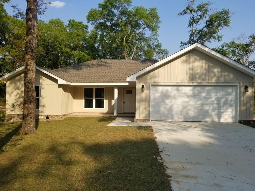 New Construction Home sitting on a LARGE LOT located in North Crestview. This charming vinyl siding with brick skirting home features an open split floor plan. The kitchen boasts lovely cabinetry, granite counter tops and a pantry. The dining area features a sliding glass door which gives a lovely view of the backyard and also has a doggie door so your pet can go in and out without opening the sliding door. The master bath has a garden tub, a separate shower, a double vanity and a walk- in closet. Just outside the master is a large laundry room and a two car garage.  On the opposite side of the home is two guest rooms and a bath.