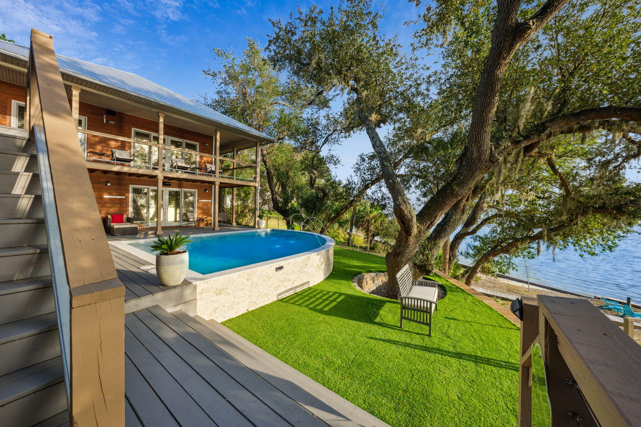 Breathtaking views and gorgeous sunsets await you at this incredible Bayfront retreat nestled at the end of its own private gated drive! This remarkable home is surrounded by lush landscaping and mature Live Oaks that provide the sanctuary you've been searching for. Featuring over 3,000 square feet of luxury with 4 bedrooms (two master bedrooms - one on the first floor and the other on the second floor overlooking St. Andrews Bay) along with 3.5 baths, plus a completely remodeled and updated carriage house with 2 bedrooms and 1.5 baths, giving you a total of 6 bedrooms and 5 baths. The Chef Inspired kitchen is the perfect place to gather with family and friends as you watch the dolphins play right from your family room!