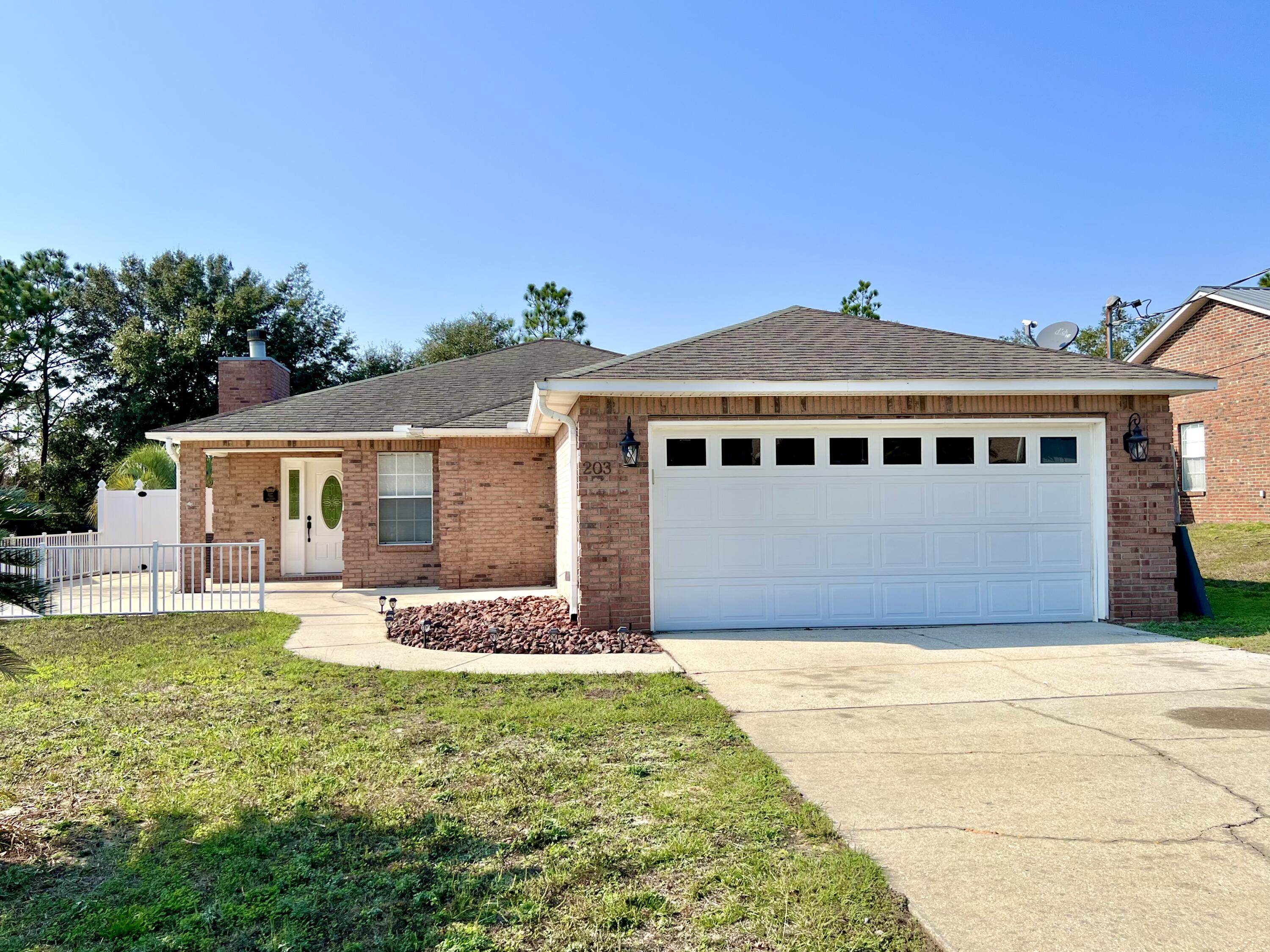 Available now!!!! South of I-10 home boasts open concept floorplan with a MOTHER-N-LAW SUITE....Primary home is 3/2 floor plan and suite features 1/1 just steps from the main home. Newer paint throughout the home. New granite in the kitchen with plenty of cabinet and counter space. Kitchen island and stainless appliance package. Ceramic tile for the flooring with fireplace and spacious bedrooms and bathrooms. 2 car garage, privacy fenced back yard and pets allowed with owner approval. No inside smoking. No inside vaping. Easy commute to bases, beaches and shopping. Suite can be an office space, work out or gaming room. A must see for convenience and affordability.