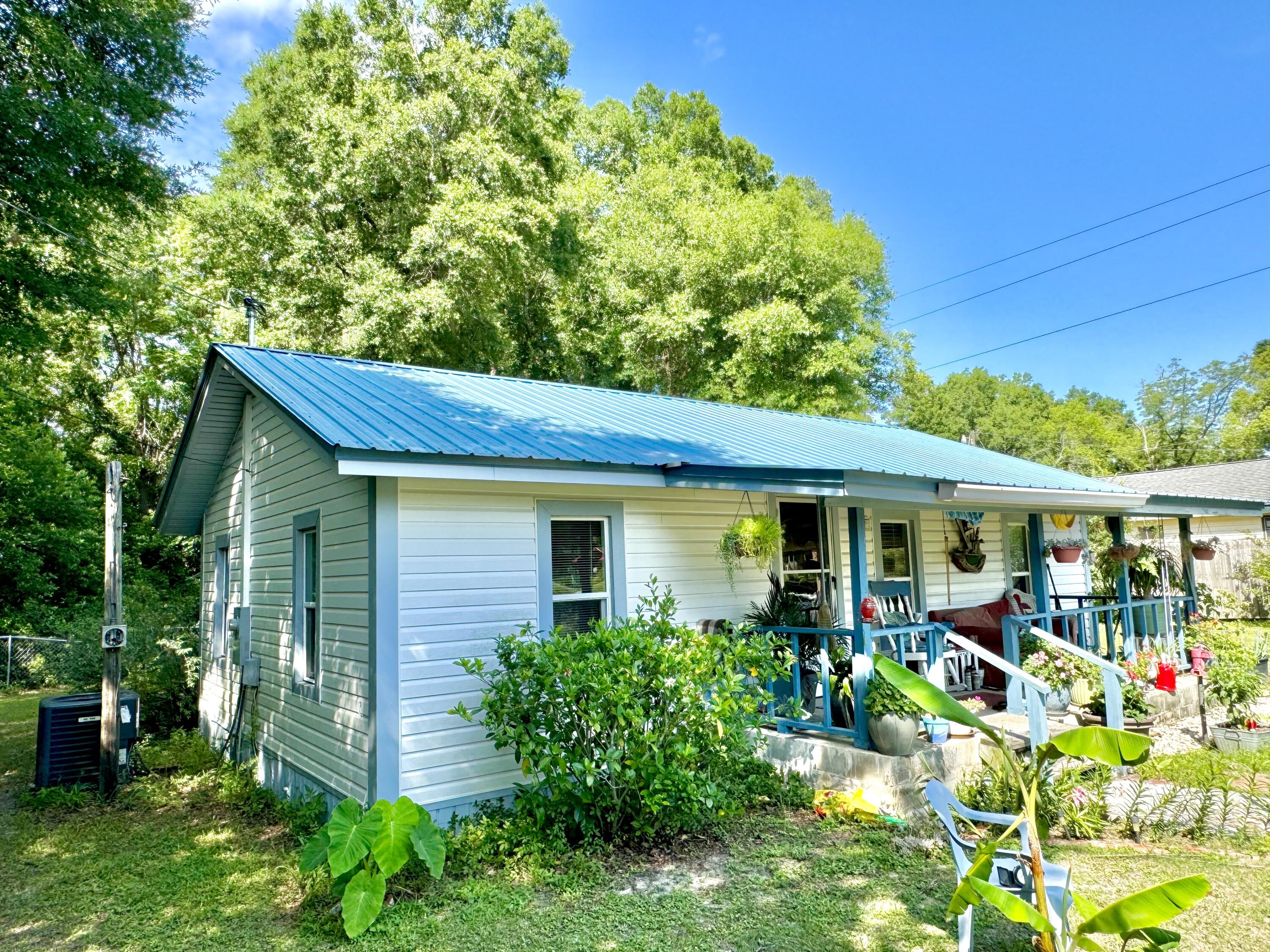 Prime residential property for sale within city limits, featuring a 3/4 acre lot zoned for light Industrial use, Can be used residential per City of DeFuniak Springs. The property includes a newly renovated home with 2 bedrooms and 1 bathroom, ideal for on-site management or family living. Renovations completed in 2020 include a new roof, windows, and A/C unit. The expansive lot offers ample space for parking, storage, or future expansion. This versatile property combines modern comforts with industrial functionality in a prime location with easy access to major roads and urban amenities. Don't miss this unique opportunity.