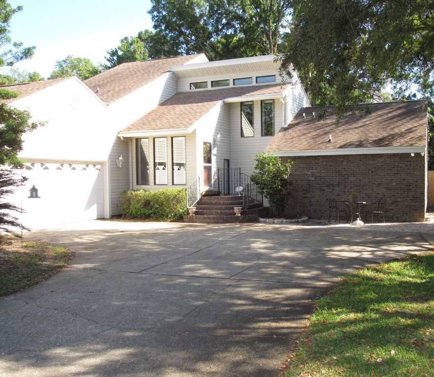 Beautiful 3 Bdr/2.5 Ba split level in the heart of Raintree Estates, a beautiful family community. Master Bedroom on first floor with master en suite and large walk-in closet. Sliding glass doors lead directly to the decked gazebo. Two large bedrooms upstairs with a Jack n Jill bathroom in between. Natural light floods the upstairs loft making it a great artist's nook. Garbage Disposal and Dishwasher recently were replaced. The great room boasts high cathedral ceilings with floor to ceiling build-ins to make a lovely library or to display trophies. The living room also has a large wood burning fireplace. Separate laundry area leading to massive two car garage. Short walk to the Beach Park or Wood Lands Park.