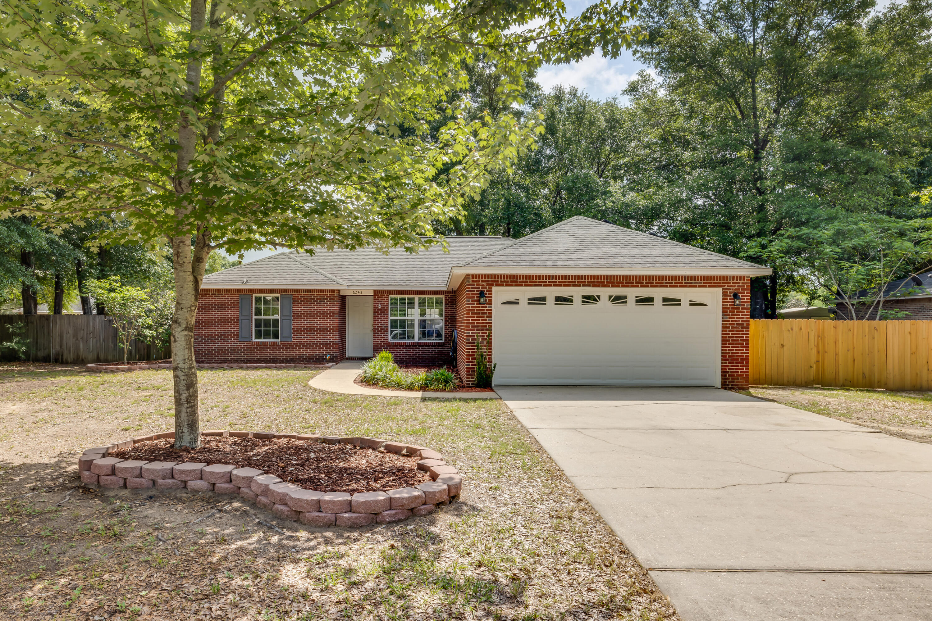 NEW ROOF!(at closing)ENERGY EFFICIENT HOME!2.8% APR Assumable VA Loan! Welcome to 6243 Winstead Rd--a beautifully maintained 3-bedroom, 2-bath brick home in Crestview's Auburn Acres. This 1,247 sq ft gem features a desirable split floor plan, laminate flooring, and tile in the kitchen and dining areas for easy upkeep. The spacious master suite offers a walk-in closet, garden tub, and a double marble-top vanity.Seller will also pay off solar panels at closing--giving buyers long-term energy savings at no extra cost! Enjoy added value with cellulose insulation, French doors to a 14x16 patio, fenced backyard, and a double garage. Conveniently located near Crestview High, Davidson Middle, the public library, and more. This home checks all the boxes!