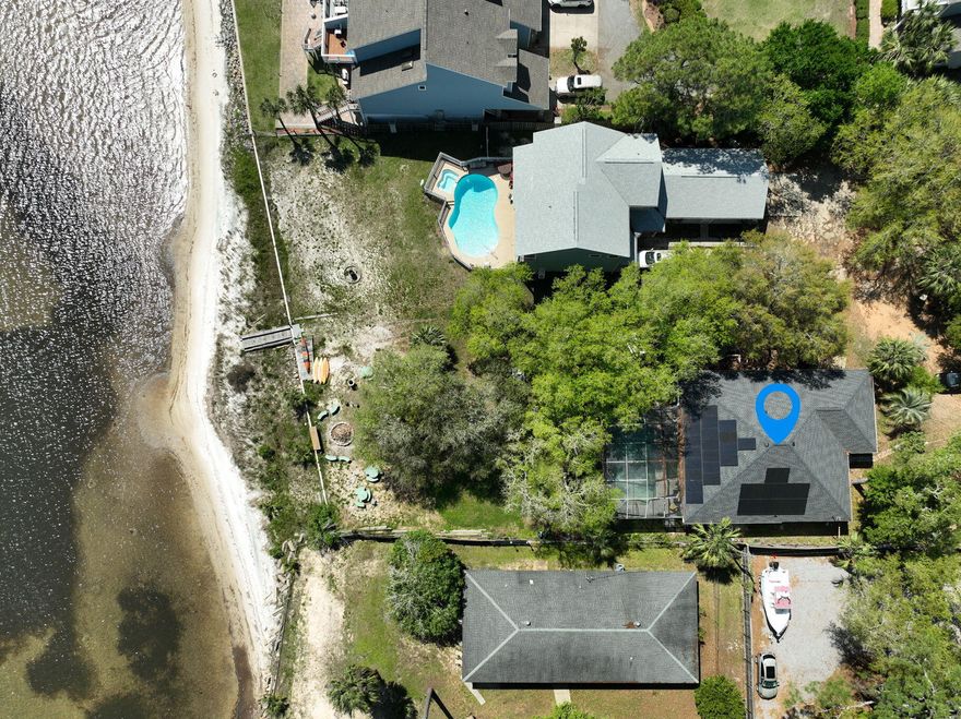 Location Location Location! Discover your Personal Oasis with this stunning 3-bdrm, 2-bath home spanning 1901 sqft on a .73 acre waterfront lot. Embrace the tranquil Soundside view from your lanai, complete with a pool surrounded by majestic Oak and Palm trees. This all-brick detached property offers a wood burning fireplace, solar panels, newer roof and HVAC. Ideal for water enthusiasts, there's plenty of space for your boat, kayaks, or paddle boards. Enjoy a picturesque sandy beach in your own backyard. With highly rated schools nearby and NO HOA! This home offers both potential and charm, ready for your updates. Boxes of new tile flooring, vanities, and appliances are included, making it a dream project. Full RV hookup available. Amazing opportunity in a prime location awaits you!
