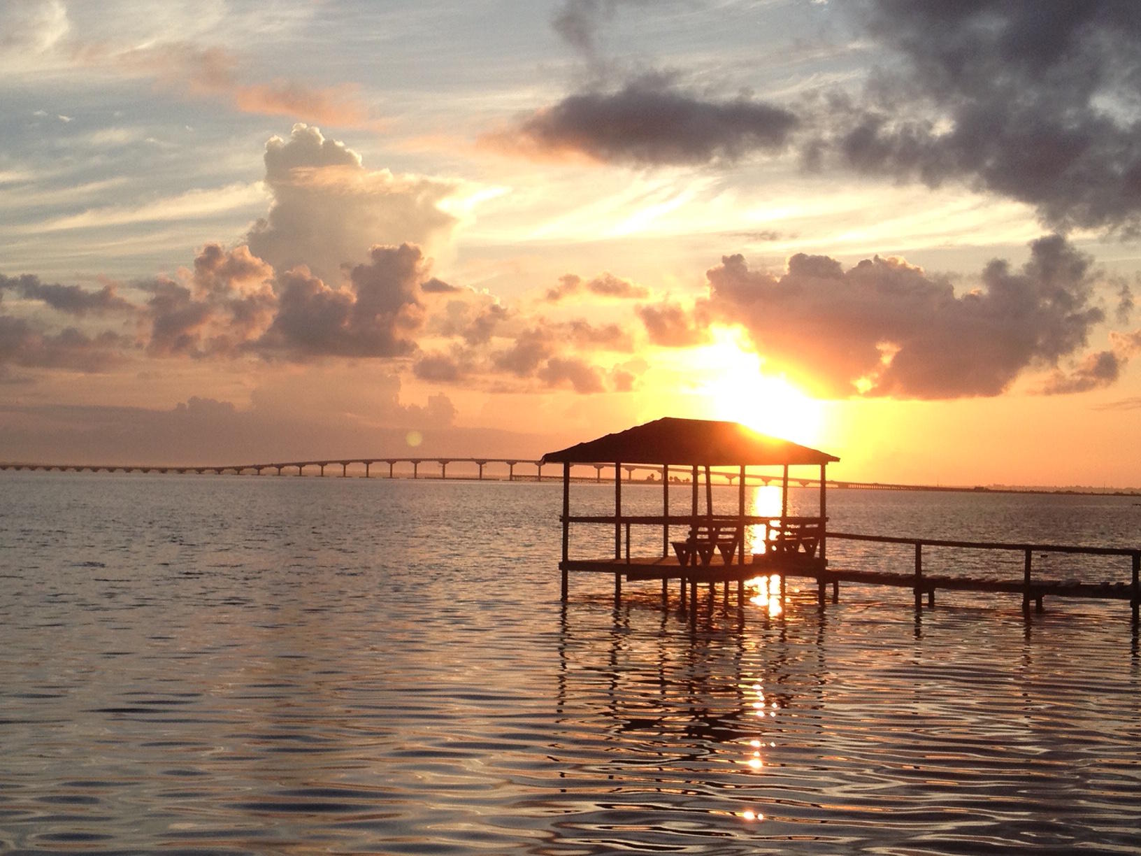 Featured in HGTV magazine in 2013 this big open water bay front home has it all! With 120 ft of water frontage a dock with boat house. Huge lot with plenty of parking and covered storage areas.