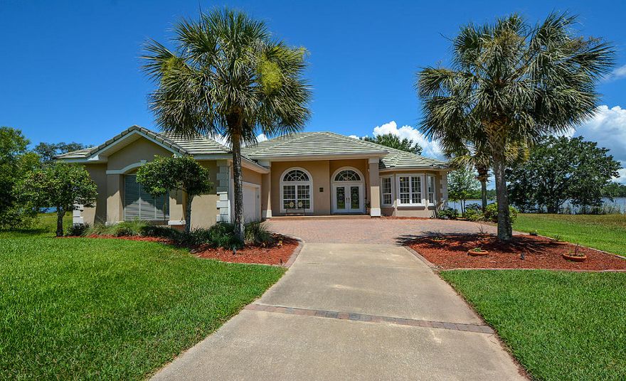 NEW PRICE on LaGrange Bayou Home! Impressive retreat in the Gated Waterfront community of LaGrange Cove, with paverstone drive, street lights, nature preserve & lakes. Home is designed for enjoyment of the Bayou & Florida Life! Expansive views of LaGrange Bayou, the Intracoastal Waterway. Protected waters give safe harbor, a very important factor for Boaters. This stucco home with flat tile roof is elegant & inviting. Screen enclosed pool & hot tub overlooks the boat dock with lifts. Interior is warm & comfortable with 10' & 12' ceilings, custom crown mouldings, plantation shutters, open floorplan, fireplace, built-in bookcases & more! Great natural sunlight & waterviews from almost every room in the home. Kitchen equipped w/ gas Thermador 5-burner cooktop, granite tops, custom cabinets,