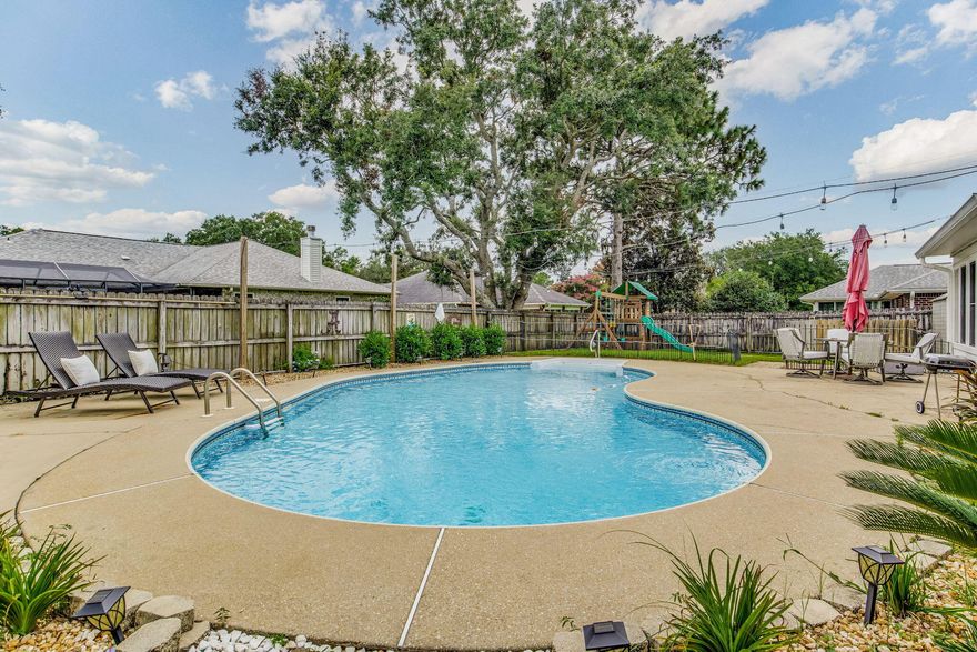 ASK ABOUT THE 2.75% FHA ASSUMABLE LOAN! Beautiful POOL home with neighborhood water access in the friendly, waterfront community of Villa Danielle. This all-brick home features a spacious, split floorplan with 4 generously sized bedrooms,. Recent updates include a NEW roof in 2019, NEW windows in 2017, NEW pool liner in 2021, plus a transferable Termite bond.Inside this lovely home you'll find both a formal dining room and breakfast nook, plus a bright sunroom that's fully heated and cooled. The living room features a wood-burning fireplace , vaulted ceilings and Oak hardwood floors. The kitchen is equipped with newer Modern Slate appliances, along with a handy Pantry.  Step outside to discover the well kept gardens, which features a large Saltwater Pool, lawn area and expansive patios. Location is everything, and this one will does not disappoint! Nestled in a small community on East Bay, this 'Reel' friendly neighborhood features waterfront access with a small pier where you can fish, marvel at stunning sunrises and sunsets, spot Dolphins or even launch your kayak! You're also just a short drive from beautiful Navarre Beach, offering endless opportunities for sun, sand, and surf....but that's not all - with easy access to great local schools, shops, dining and an easy commute to Hurlburt Field, convenience is on your doorstep. Schedule your private tour today. Your dream home awaits.