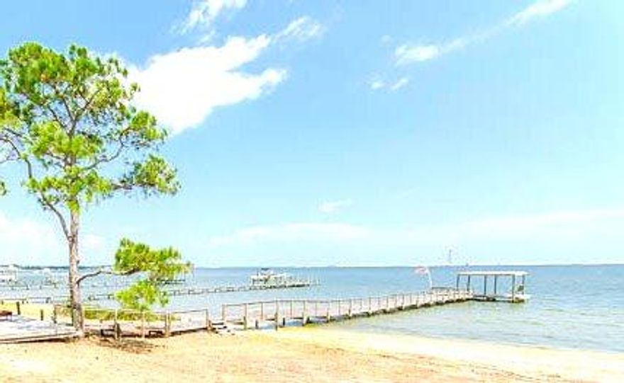 ONE OF A KIND 1.27 ACRES, 150 FEET ON THE WATER PRIVATE ABODE! COME ENJOY THIS BREATHTAKING VIEW EVERY MORNING & EVENING. You will LOVE the Water views from every room in the Home as windows span the entire rear of this 3000 sqft OPEN Design. Sliding Glass Doors allow you to step into your Dreamy 1000 sqft patio as you breath in serenity overlooking this natural waterside white sandy beach view! So many things to love to include; Vaulted Cedar Ceilings in your Family Room, Gas Fireplace, Bonus/Office right off the living room, Lovely original solid wood built-in cabinetry & media center, Spacious Laundry room with Tons of Extra Cabinet space, Walk in Storage closets & more! Although you may want to add your own special touches this kitchen offers a wonderful layout to include large  island & 6 Stool Bar Top, Gas 5 top Thermador Range & Double Oven, Dishwasher and Refrigerator all stainless steel and only 2 years new. Corian Counter-tops & of course not to forget amazing views of the water!  Office, Bedrooms & Living room all have private sliding glass doors to a newly painted deck/patio offering built in seating, entry to your private dock & beach as well as planters just waiting to accent the natural awe-inspiring view. Take a walk down this newly re-built Dock with railing to add to your comfort & enjoy a seat in the Solid Wood "Dream Swing". Don't worry there is no such thing as sitting too long in this escape. You may even be visited by the Local Heron "Grunk" as they call him looking for his daily fish snack the owners so graciously left him. This 3 Bedroom Split Floor plan offers over 200 square feet in the master with large walk in closet, extensive master suite, double vanity, separate shower and of course lined with large windows ensuring a beautiful water view. You can't miss this large bonus loft room can be used as an studio, hobby room, private office or play area, equipped with a sink & immaculate views of the water all accessed by a beautiful winding staircase. Don't forget to open the closet door which accesses an enormous cedar lined attic storage space. Exterior features include natural landscaping, privacy from neighbors & street, Lawn pump, sprinkler system, exterior storage & oversized 2 car garage. Updated features include newly scrapped ceilings with knock down texture, recessed can lighting, monitored security system, Built in Fabric Hurricane shutters with cranks handles, 25 year Architectual Steel Roof (2004), 2 Lennox HVAC systems one replaced in 2011. Terminix Termite Bond, 2012 Stainless Steel Double Oven, 2013 Dishwasher, 2015 Refrigerator. Home does have Handicap accessible features to include shower in Master that can be easily converted back to Jacuzzi or Garden tub. Make arrangements to view your DREAM HOME today!