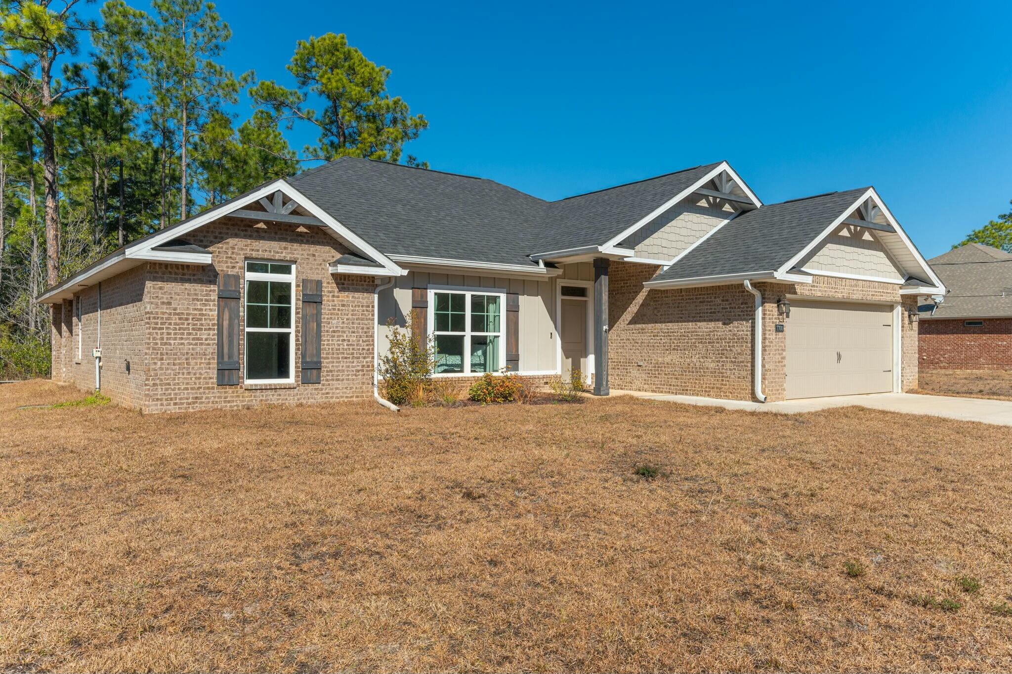 This stunning 4-bed, 2-bath home, built in 2021, blends modern luxury and comfort on a spacious half-acre lot in Navarre. The smart split floor plan offers privacy and open living spaces, ideal for families. The chef-inspired kitchen features a large island perfect for meal prep and entertaining, while the separate dining room adds elegance. The master suite includes a walk-through laundry room leading to a massive walk-in closet for added convenience. High ceilings, contemporary finishes, and a functional layout make this home a must-see. Schedule your showing today.