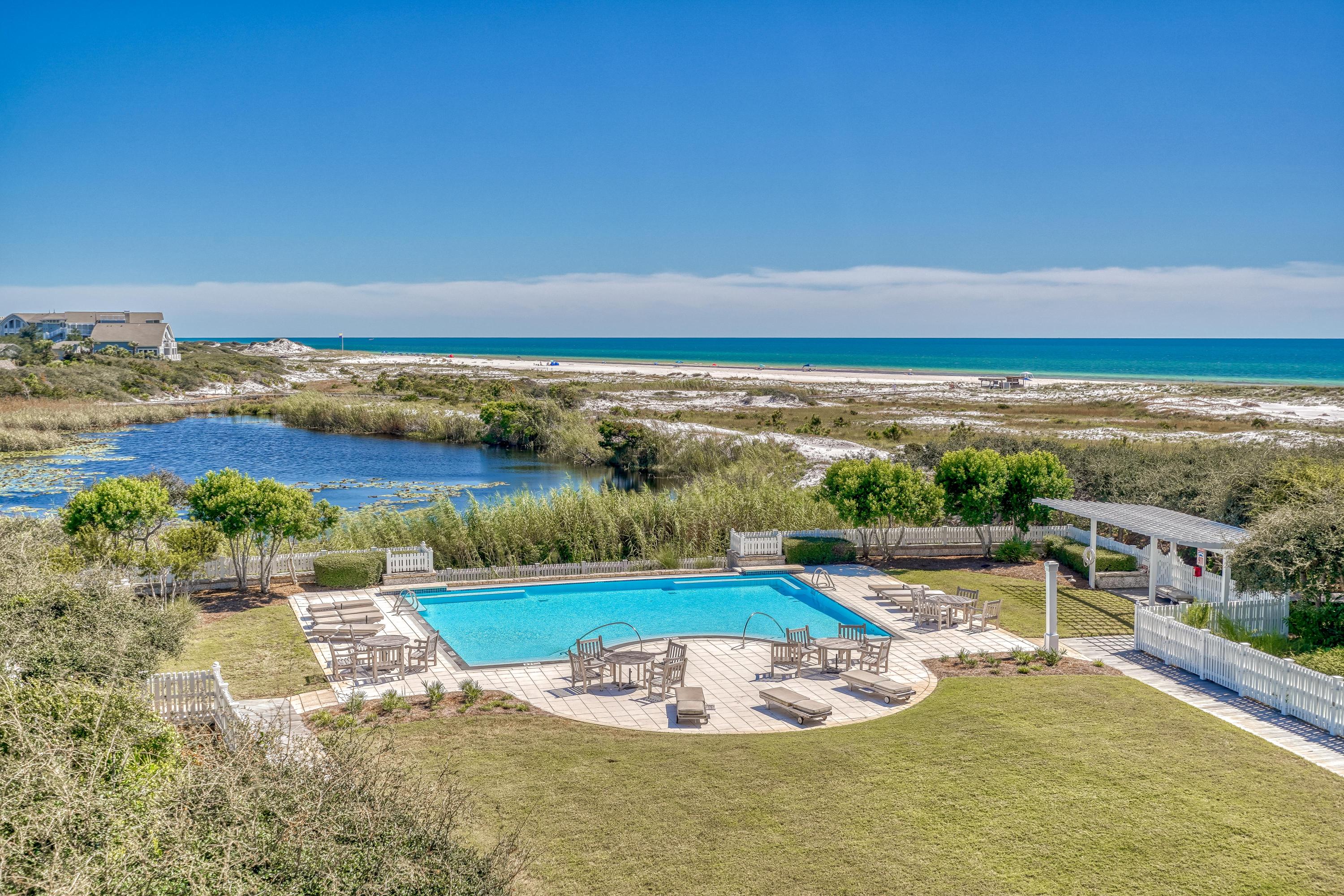 Enchanting gulf and lake views characterize this impeccably renovated gulf front 3BR/3.5BA residence in Compass Point II in the WaterSound Beach community. A welcoming open concept design makes entertaining effortless while each bedroom offers an ensuite bathroom for added privacy. From the moment you enter, notice custom upgrades throughout including new oak hardwood floors, designer lighting, updated bathrooms, and designer furnishings. A calming color palette and design details such as board and batten in the living and dining area and luxury wallpaper creates sophisticated coastal retreat.The kitchen has been fully upgraded with a new larger breakfast bar, floor to ceiling cabinets and a white geometric backsplash. Viking appliances include a wine refrigerator.