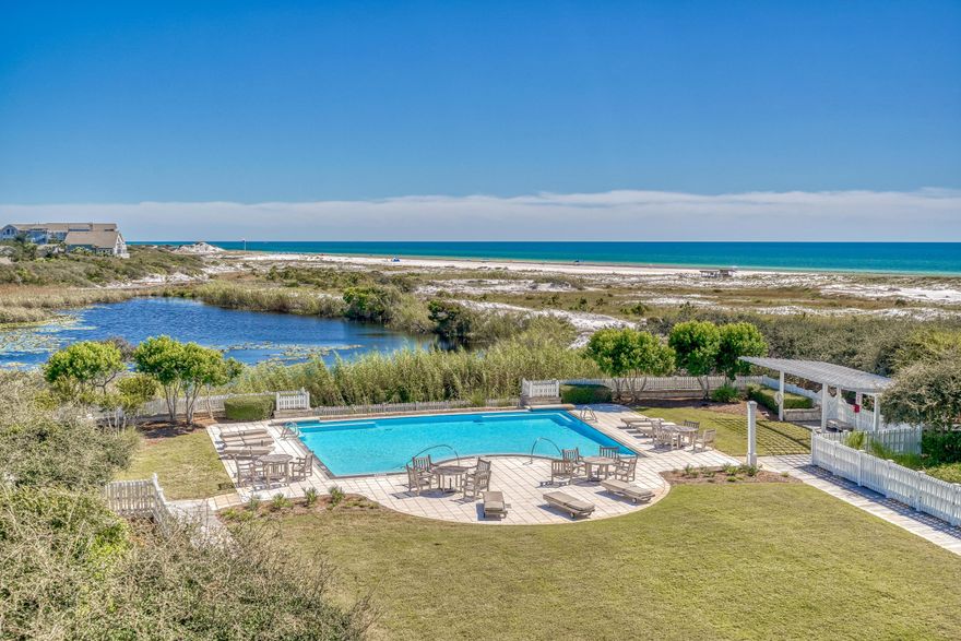 Enchanting gulf and lake views characterize this impeccably renovated gulf front 3BR/3.5BA residence in Compass Point II in the WaterSound Beach community. A welcoming open concept design makes entertaining effortless while each bedroom offers an ensuite bathroom for added privacy. From the moment you enter,  notice custom upgrades throughout including new oak hardwood floors, designer lighting, updated bathrooms, and designer furnishings. A calming color palette and design details such as board and batten in the living and dining area and luxury wallpaper creates sophisticated coastal retreat.The kitchen has been fully upgraded with a new larger breakfast bar, floor to ceiling cabinets and a white geometric backsplash.  Viking appliances include a wine refrigerator.