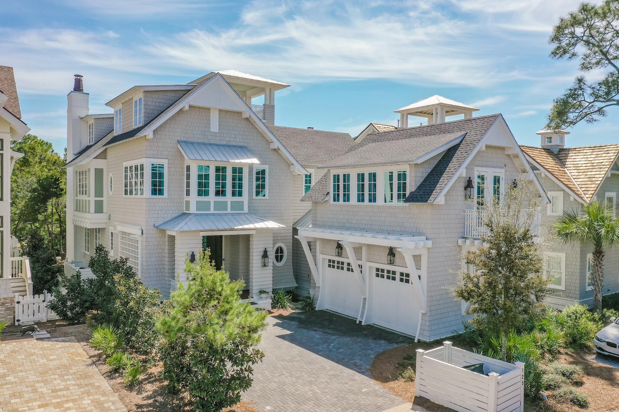 Located behind the private gates of WaterSound Beach, this coastal retreat boasts over 4,800 square feet of thoughtfully designed living space executed by the sought after architect T.S. Adams and the renowned building team at Dune Construction. A true icon of craftsmanship, the highest level of finishes and articulated positioning taking full advantage of the covetable Gulf views can be appreciated throughout. Upon entering the front door you are greeted by the foyer with charming ship lap lined walls and stunning wood flooring. Flowing seamlessly into the living area, the Chef's kitchen features custom cabinetry, an oversized island with an integrated breakfast bar, and a luxury appliance suite.