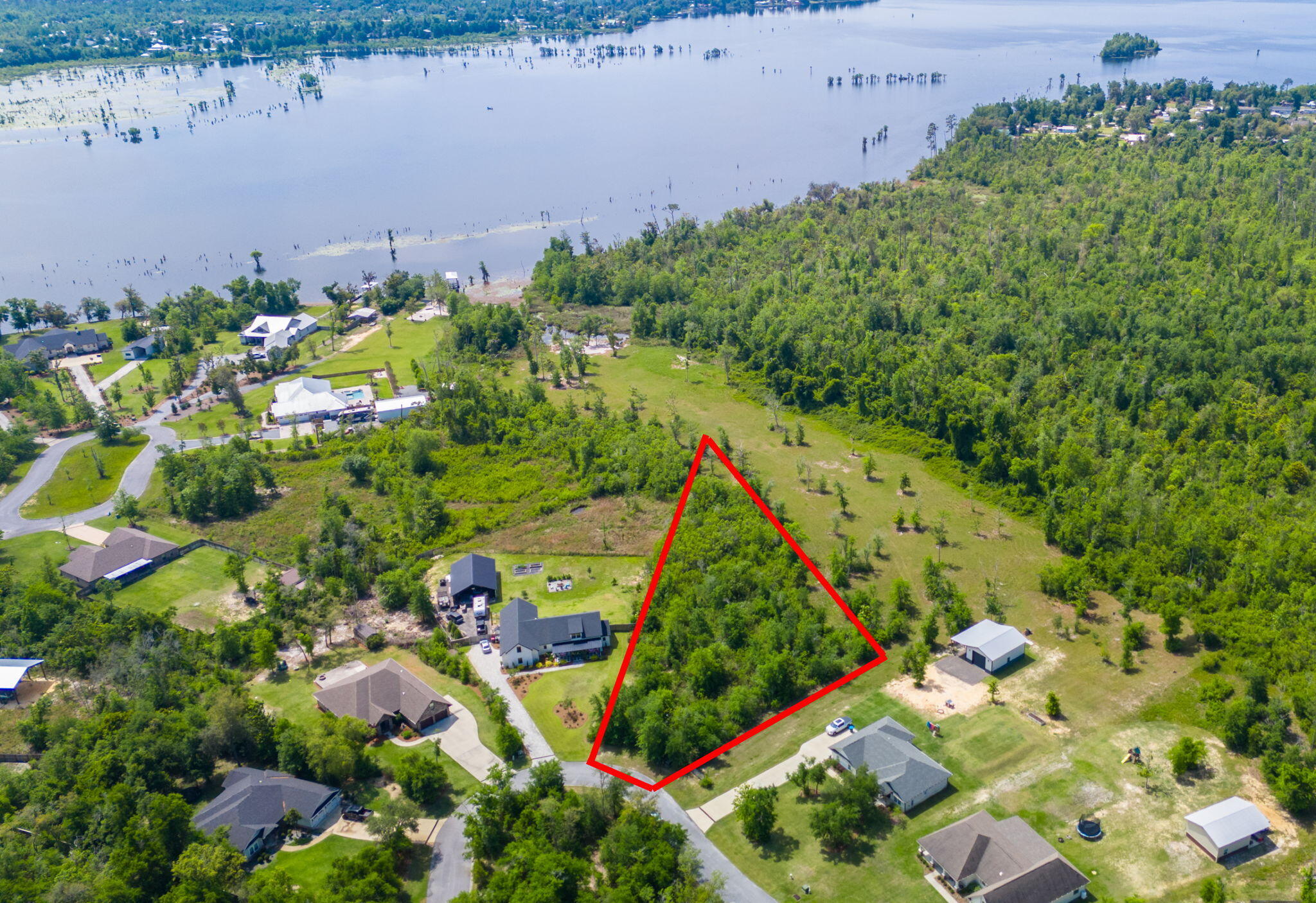 Get ready to build your dream home on this .94-ACRE homesite in the highly desirable, Cedar Creek community on Deer Point Lake!This homesite is high and dry, in zone X and an incredible opportunity to develop your own dream oasis. Envision living your best life with an expansive yard, detached garage for all the toys, a pool where the family can play year round and so much more!Cedar Creek is a master-planned community that harmoniously integrates with the natural landscape, preserving its tranquil surroundings for residents to enjoy for years to come. Known for its excellent fishing opportunities, Deer Point Lake is a haven for bream, shellcracker, and bass enthusiasts. Its proximity to Econfina Creek also offers easy access to the vibrant offerings of Panama City and the surrounding areas, all while enjoying the benefits of waterfront living.
Residents of Cedar Creek benefit from exceptional community amenities featuring a large community pool, playground, golf cart-friendly streets, and abundant greenspace, creating a country feel while remaining in a highly desirable location. Wildlife is abundant, enhancing the natural charm of the area. The community clubhouse is available at no cost to residents, making it an ideal venue for hosting events such as birthday parties and showers and family gatherings.
This is your chance to build your dream home!
Adjacent 5.5-ACRE waterfront homesite is also available. Please inquire for more information.