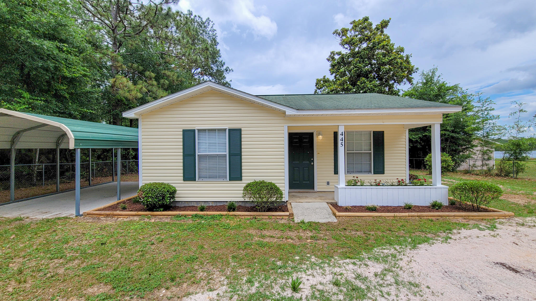 Enjoy lake life at this beautiful 2 bedroom 1 bath cottage on Lake Juniper! As you step in, you'll appreciate the open concept living space, with natural lighting and laminate flooring throughout the entire home. Inline kitchen has a refrigerator with ice maker, double sink, and electric stove w/ hood. There is an area for a breakfast / dining table, and storage room off the kitchen, complete with washer & dryer hookup. Side door leads you out to the carport. Two spacious and bright bedrooms occupy the back of the home, both with large closets and WATER VIEWS!! Full bathroom has granite countertop and shower/bath combo. Outside, enjoy a large backyard with waterside firepit and dock, perfect for fishing or putting in your kayak / paddleboard.