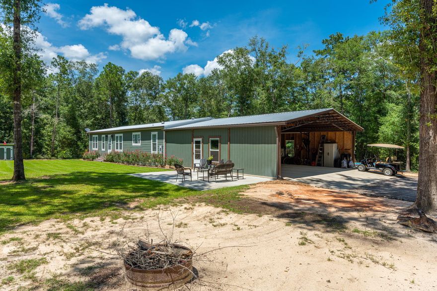 Stunning manufactured home on over 5 acres with so many extras! Hardi-board siding on both the home & the 36x30 barn. The living room boasts of tray ceilings, a stone faced electric fireplace & built-in shelving. The kitchen makes you feel right at home with the island, subway tile backsplash & farm sink. The dining room is set perfectly for that farmhouse style dining table that you have always wanted. The exposed beams and barn door add the perfect amount of character. The master bedroom suite has both a walk-in closet and a master bathroom that gives you all of the comfort needed with the double sinks, tiled shower and separate soaking tub. Have I mentioned the above ground pool, outdoor entertaining space, the creek, the private gated entrance & the circle driveway? Need I say more...