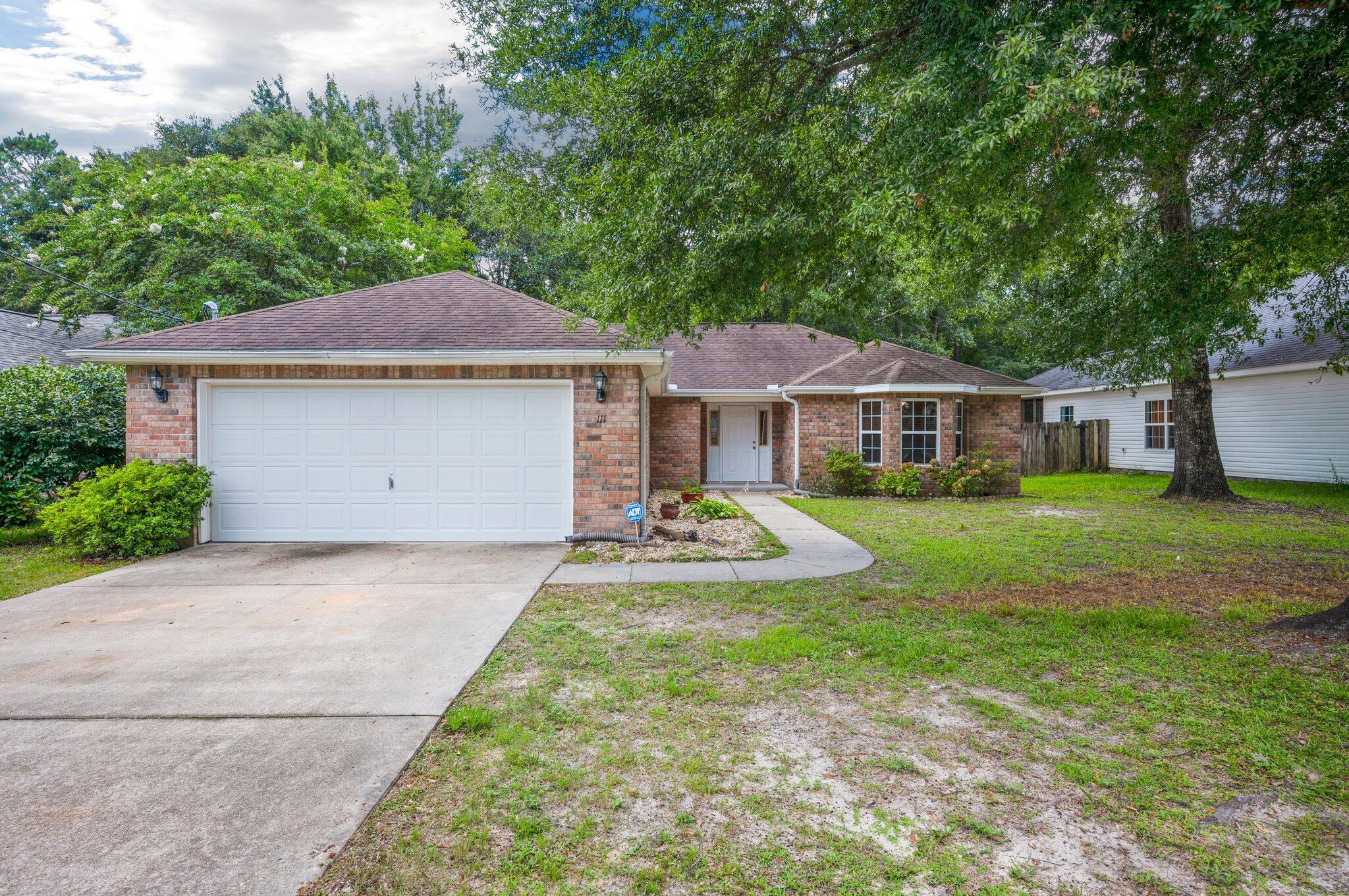 MOVE IN READY with fresh new paint throughout and new LVP flooring! No carpet at all! All brick home with dimensional shingle roof and double car garage. Upgraded maple cabinets and Corian countertops with under mount sink. Stainless steel appliances. Microwave range hood and smooth cook top self cleaning range. Ceramic tile floors in kitchen, laundry room, and both baths. Split bedroom design. Large master suite (check out the closet!). Bedroom 2 has bay window. Trayed ceilings in dining area and master bedroom. Covered rear porch, & privacy fenced back yard,