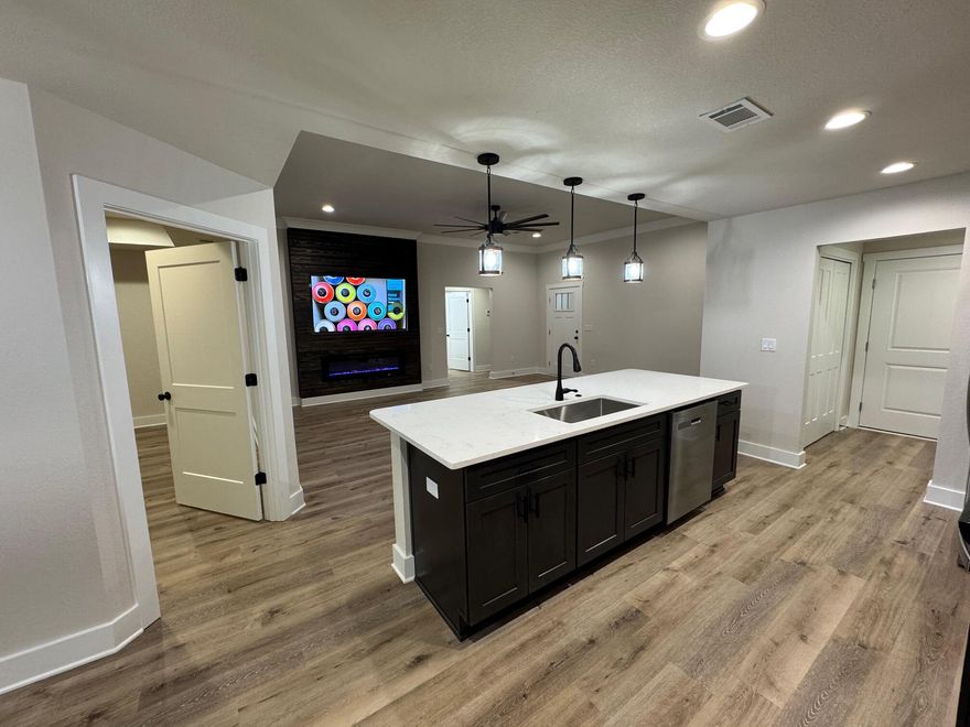 Swipe Right on this house!  Closing cost help available. This new construction home is perfect if space, quality & upgrades is your thing! The rooms are a decent size & the closets too. There is a formal dining room area & a large quartz island. The builder added crown molding for drama! The front & back porches are covered; backyard is huge & privacy fence is already up! Perfect, right!The Builder went ahead & threw in all of the appliances such as the washer, dryer, fridge, microwave, oven, 75-inch TV & electric fireplace!Your new home is less than a mile from downtown Crestview (food tucks, events, shopping. restaurants), only 8 from Dukefield, 20 from Eglin AFB, & more! It's also within district for highly rated schools. There's only 1 thing missing, YOU!! Professional Photos Coming Soon!