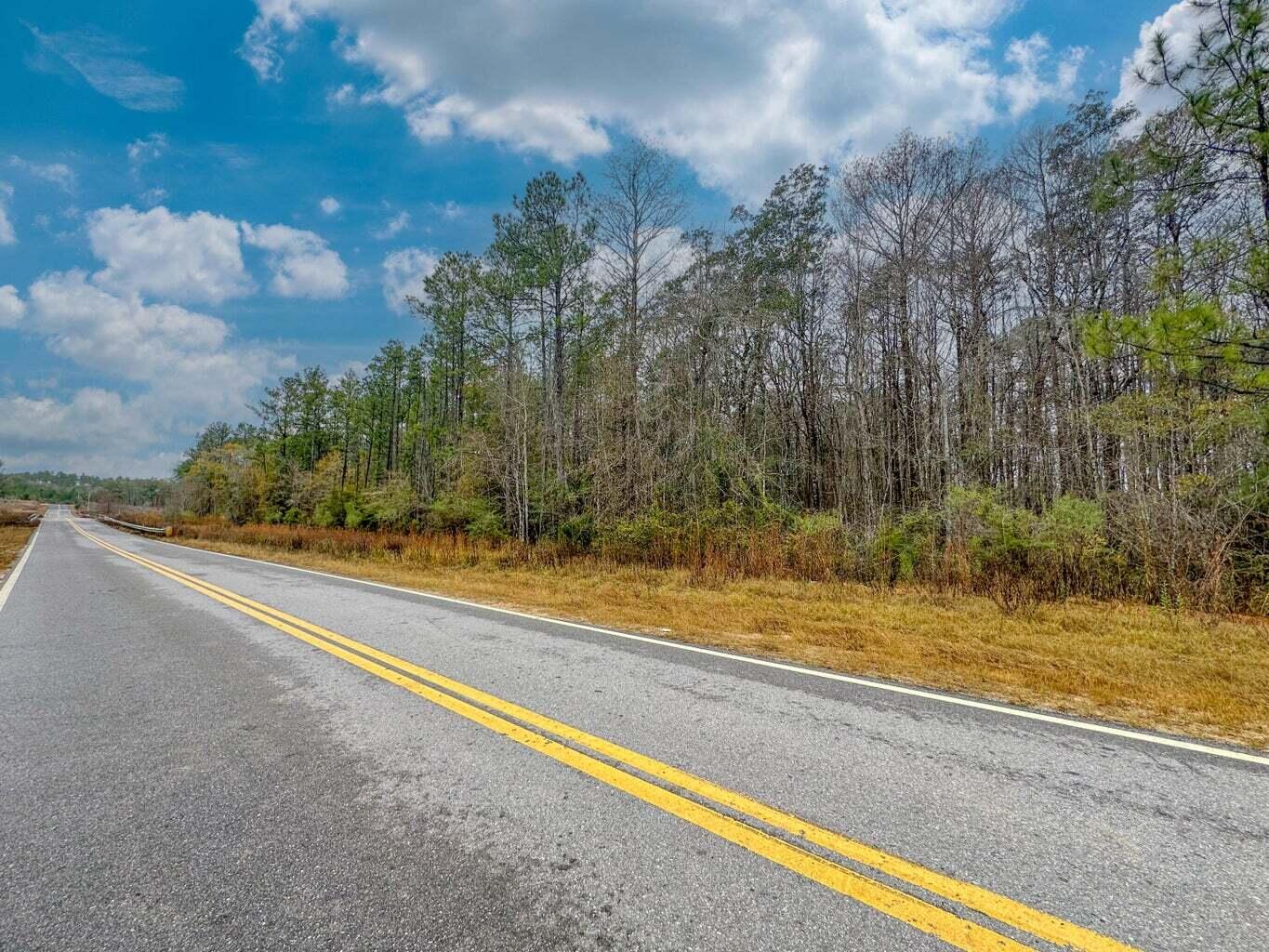 Spanning approximately 250.72 acres, this tract offers a mix of open and wooded areas with a creek running through part of the property. Paved road frontage provides access, and power is available. The land is suitable for multiple uses including residential building, agricultural purposes, or recreational activities. Located on River Road in Caryville, the property allows convenient access to I-10, Hwy 79, Hwy 81, Hwy 90, and Panama City Beach.