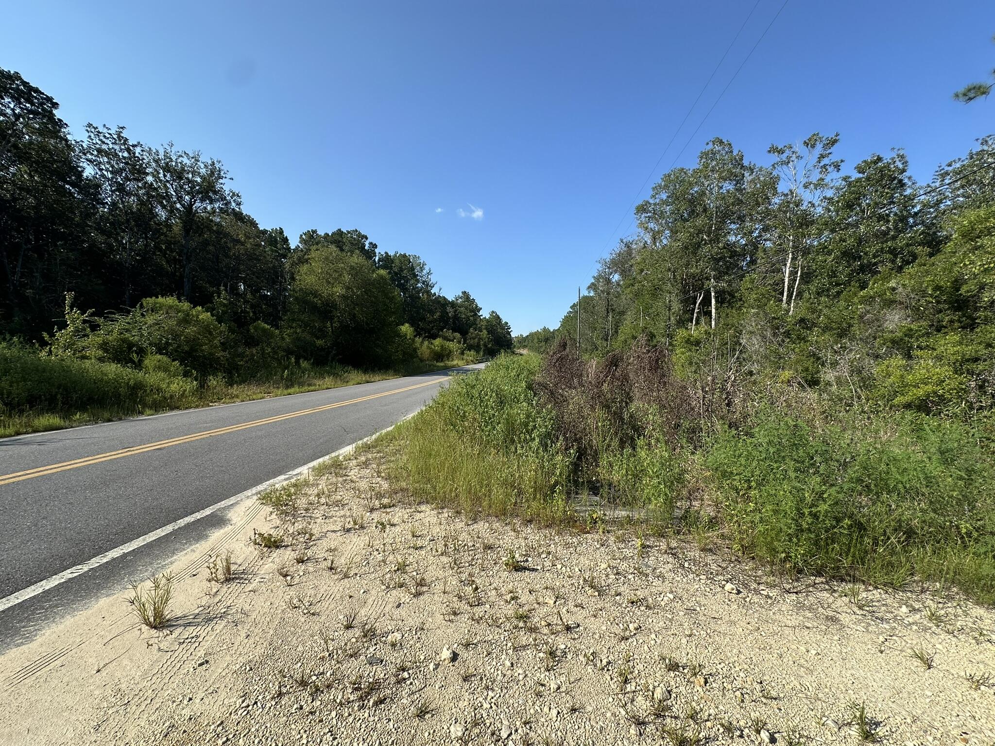 Spanning approximately 250.72 acres, this tract offers a mix of open and wooded areas with a creek running through part of the property. Paved road frontage provides access, and power is available. The land is suitable for multiple uses including residential building, agricultural purposes, or recreational activities. Located on River Road in Caryville, the property allows convenient access to I-10, Hwy 79, Hwy 81, Hwy 90, and Panama City Beach.