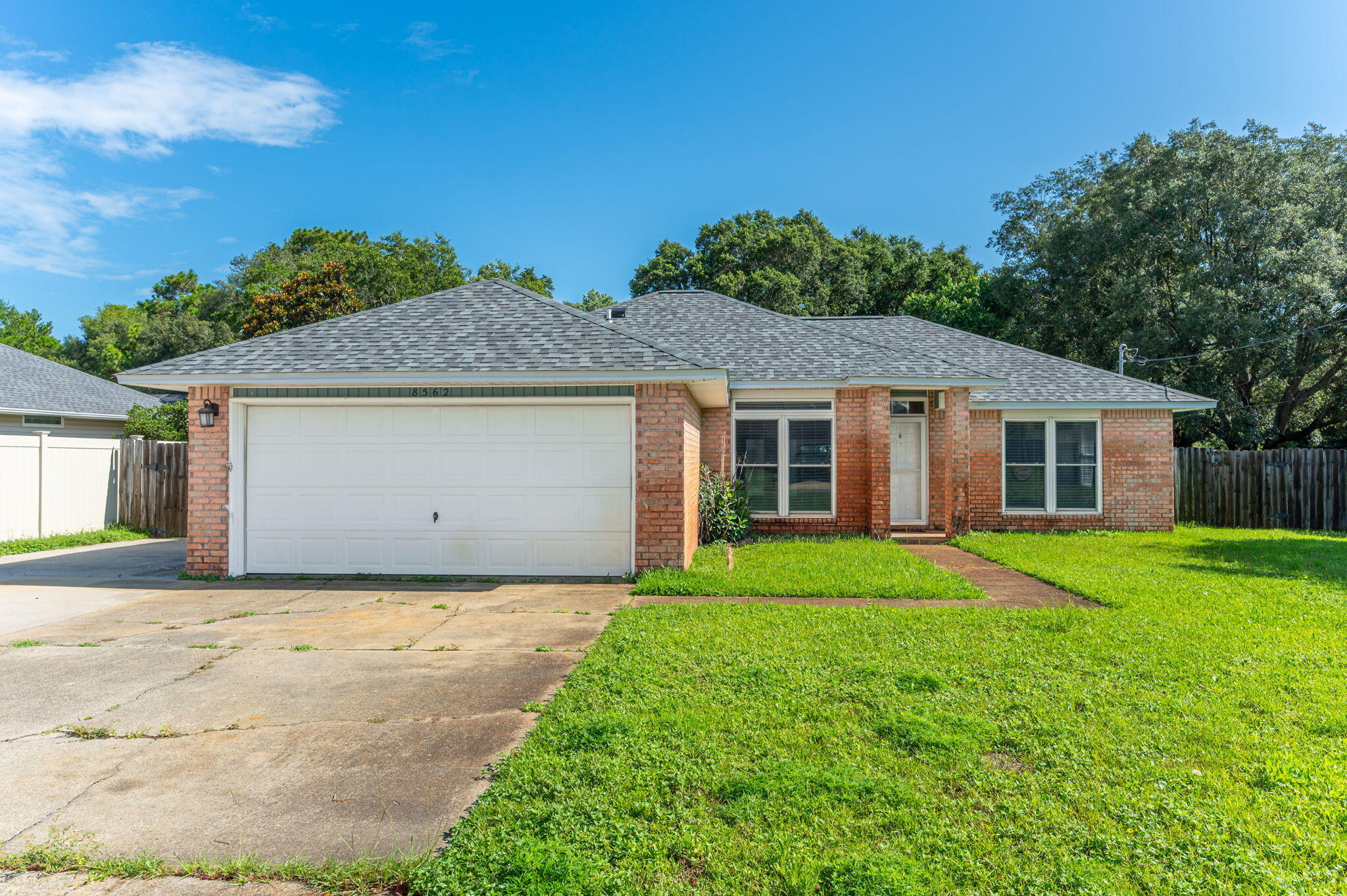 Location is everything--and this home delivers! Perfectly situated near Navarre High School, the Navarre Youth Sports Association fields, and the local YMCA, this property offers convenient access to top-rated schools, youth athletic programs, and fitness facilities, making it ideal for active families.Peace of mind comes standard with a brand-new roof installed in 2024 and hurricane impact windows. Inside, the split floorplan creates privacy and flow, with the master suite featuring his and hers walk-in closets and a generously sized master bathroom, perfect for relaxation.Step through the French patio doors into a large backyard--a blank canvas for outdoor entertaining, gardening, or creating your own personal oasis.