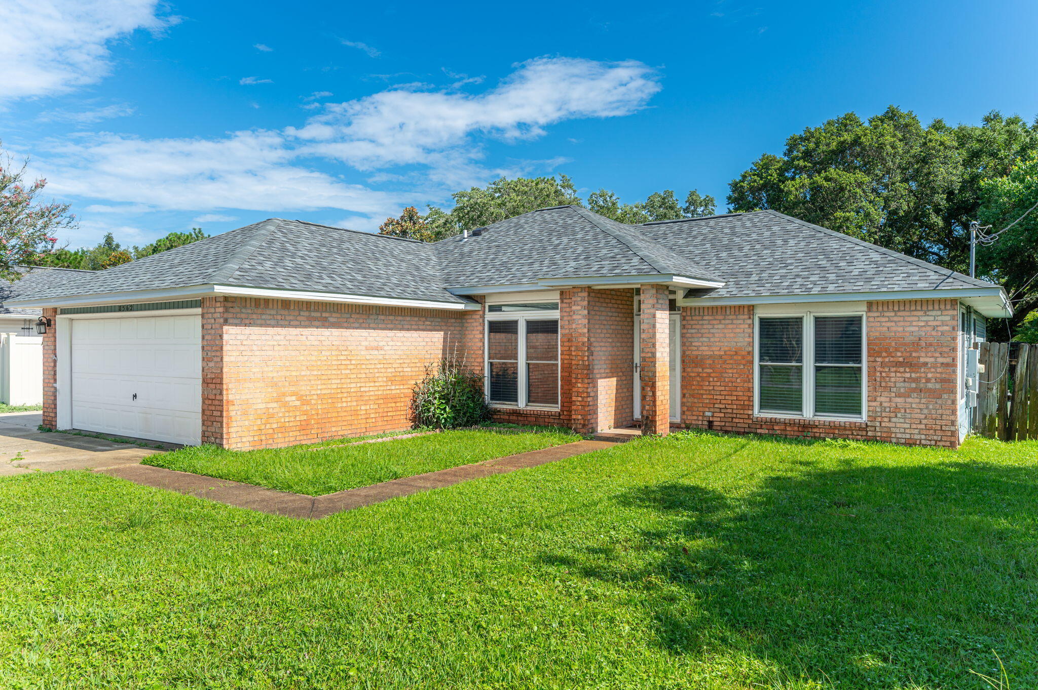 Location is everything--and this home delivers! Perfectly situated near Navarre High School, the Navarre Youth Sports Association fields, and the local YMCA, this property offers convenient access to top-rated schools, youth athletic programs, and fitness facilities, making it ideal for active families.Peace of mind comes standard with a brand-new roof installed in 2024 and hurricane impact windows. Inside, the split floorplan creates privacy and flow, with the master suite featuring his and hers walk-in closets and a generously sized master bathroom, perfect for relaxation.Step through the French patio doors into a large backyard--a blank canvas for outdoor entertaining, gardening, or creating your own personal oasis.
