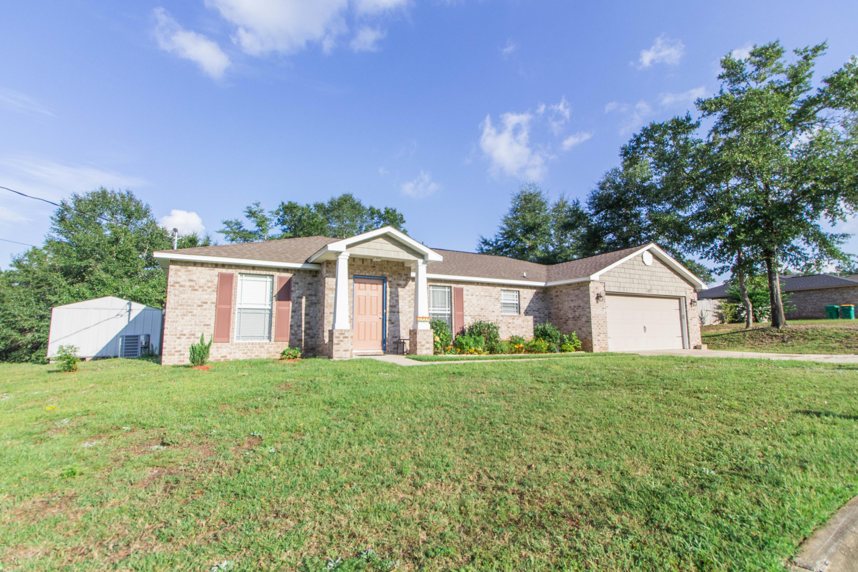 Stunning 3 bedroom 2 bath home located in north Crestview on one of the largest lots in this subdivision. The .82 acre lot provides you with plenty of space for the kids and family dog to run and play around on. There are not one, but two yard buildings to provide additional storage space for all your yard equipment allowing you to use to the 2 car garage for your actual cars. As you come inside you right away notice the spacious living room great for entertaining as well as those cozy family movie nights. The large kitchen provides ample cabinet and granite counter space for all your cooking needs. The split floor plan allows for privacy with your own large master suite and master bath. The master bath is equipped with dual vanity and walk in closets. Property backs to Okaloosa county