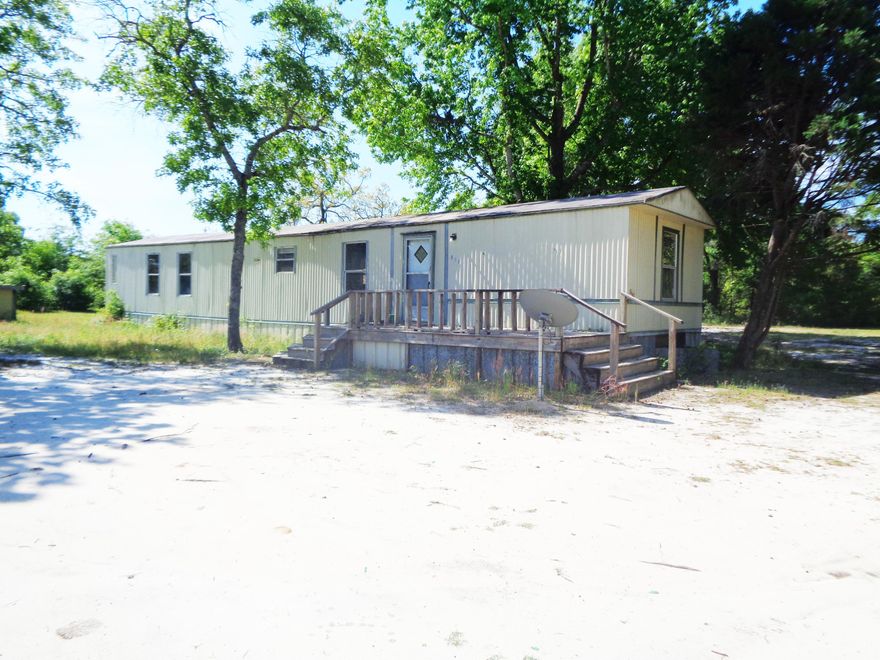 HOME WAS A RENTAL FOR MANY YEARS AT $650.00 PER MONTH. HOME OFFERS 2 BEDROOMS, 2 FULL BATHS, OPEN KITCHEN AND DINING, AS WELL AS A LARGE BACK PORCH/DECK. MOBILE SITS ON ONE LARGE LEVEL 1 ACRE LOT AND IS JUST NORTH OF TOWN.
