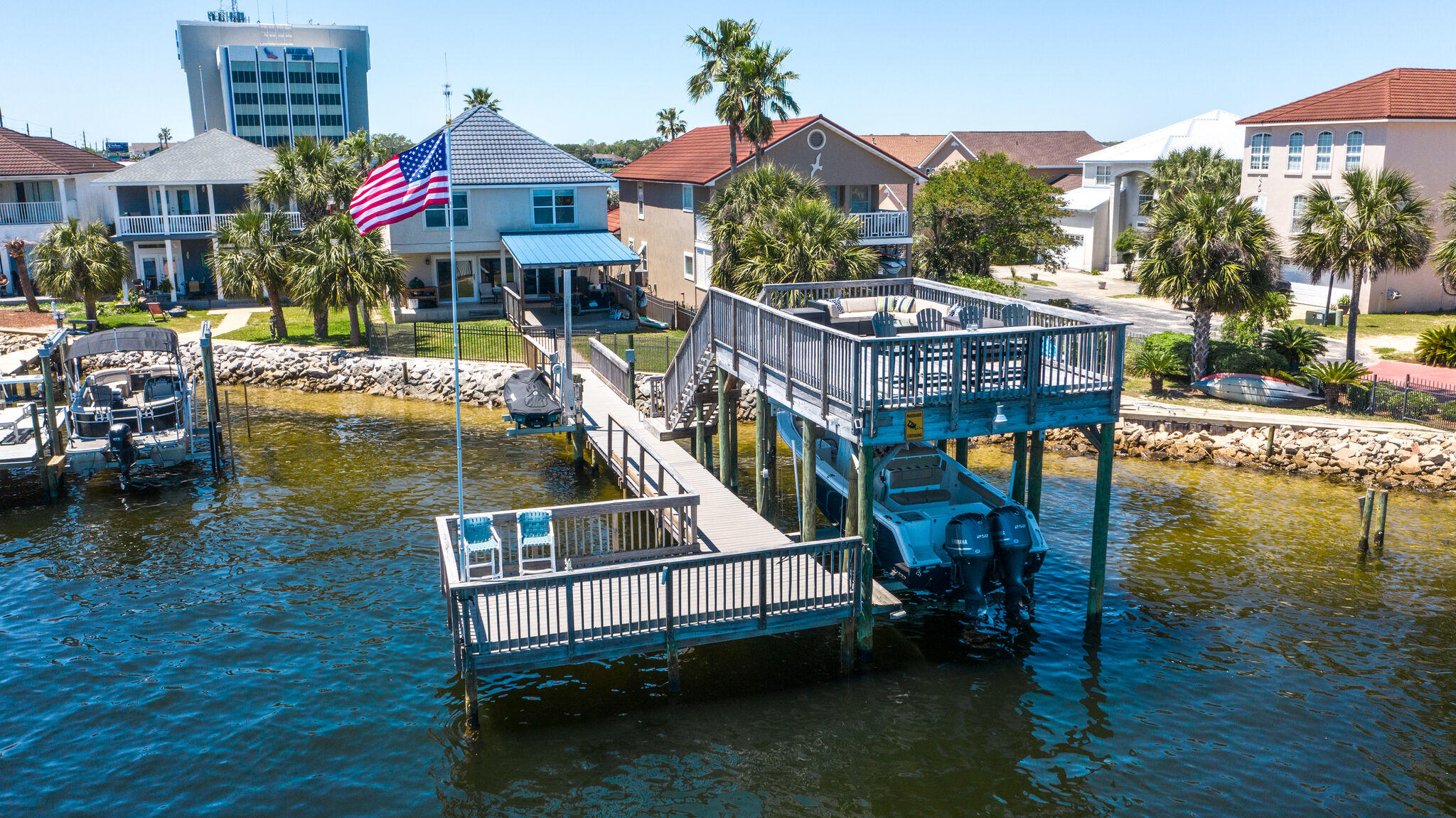 OPEN BAY ACCESS...WATERFRONT LIVING AT IT'S FINEST... GORGEOUS WATERFRONT home in GATED COMMUNITY.  PANORAMIC VIEWS with TONS of NATURAL LIGHT.  10k pound covered boat lift, upper & lower decks & jet ski lift.  DEEP WATER, PERFECT FOR FISHING, BOATING AND SWIMMING. QUICK ACCESS to BAY.  Open floorplan, custom window blinds, hurricane windows & doors and metal roof.  1st floor has wood grain tile, large open kitchen with granite counter tops, upgraded stainless steel appliances, walk in pantry, perfect for entertaining.  2nd floor conveys large family room with wet bar, perfect for pool table or game room, full hall bath, large master suite with two walk in closets, 3 additional bdrms, two with full baths.  3rd floor is a 5th bedroom or bonus space, tons of storage. Outdoor space has covered patio and upper deck dining space for outdoor entertaining, fenced in yard and plenty of dock space for paddle boards, kayaks and guests.  LOCATION, LOCATION, LOCATION...EASY ACCESS TO GULF OF MEXICO FROM GARNIERS BAYOU...Centrally located between Hurlburt and Eglin AFB.  Minutes to schools, airport, hospital, shopping, restaurants and beaches. Make your appointment today, this waterfront gem will not last long.