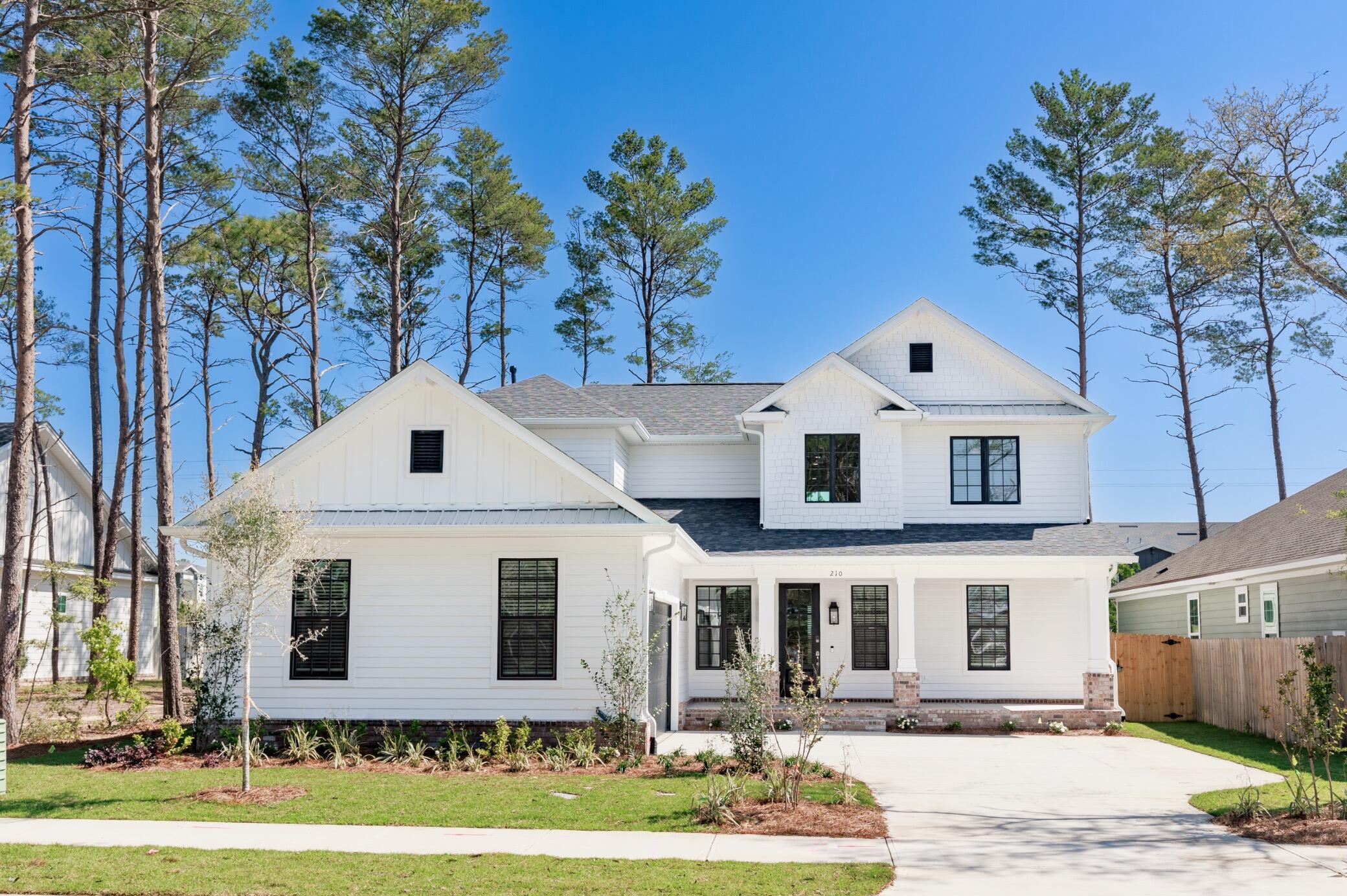 This beautiful 5 bedroom, 3.5 bathroom home is located in the highly sought-after Deer Moss Creek! This stunning 2 story residence offers the spacious master suite on the 1st floor with direct access to the relaxing lanai. The master bathroom boasts a beautiful chandelier, walk-in shower, double vanity, a white stand alone tub and a large custom wood shelving closet. As you enter, you see the french barn doors leading you to the dining / flex room. The open concept floor plan offers a spacious living room with a natural stone tile surround gas fireplace and a custom built mantel. The fabulous kitchen offers white shaker cabinets, soft close doors and drawers, quartz countertops, gas cooktop, stainless steel appliances, pot filler, white farmhouse sink and a large kitchen island. Estimated completion April 202