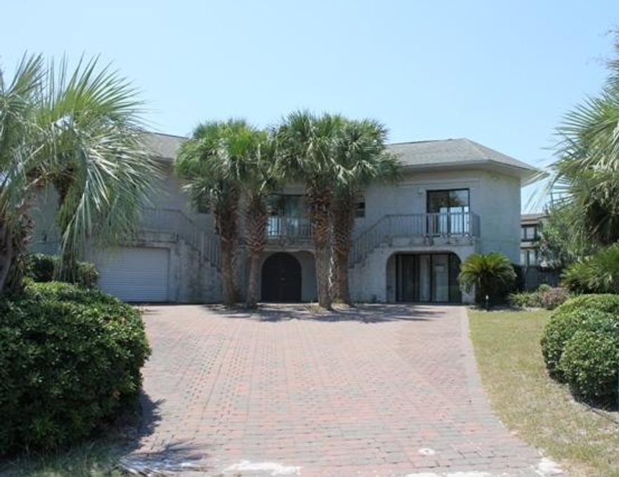 REO ~ Waterfront Living on Destin's Harbor. Situated at the end of the Lagoon Dr cul-de-sac, this 4 Bd / 3 Ba home boasts solid concrete construction, 176 ft of water front, water front pool & harbor views. Lots of Potential. The HOA informed us in July 2015, the seawall, dock & boat slips are encroaching into the Holiday Improvement Association's owned canal (common property) as much as 30ft & the two boats slips were constructed without proper permits. The outbuilding on the north side of property was built without proper permits & violates set back requirements. In researching City of Destin records, it appears there were City permits, DEP permits & Core permits for the seawall & boat slips (boat slips that are currently at property do not match what was approved).