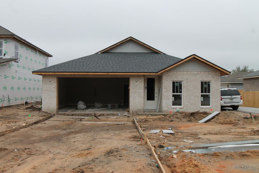Introducing ''Temple Park at Port Dixie'', a 40 lot development is Shalimar with both underground utilities and broad sidewalks. This 4BR/3BA, 2CG custom brick homesite has 10 Ft. ceilings w/ impressive crown molding, LVP flooring throughout most of the home, tile in the master bath, and 5 1/4'' baseboard throughout. Kitchen boasts custom painted Bisque cabinetry, granite countertops, a large pantry, and stainless appliances (including an oversized commercial grade refrigerator/ freezer). Master suite is in the rear of the home, is very roomy, has 2 large walk - in closets, a marble walk - in shower with glass enclosure, a whirlpool garden tub, and double vanity.