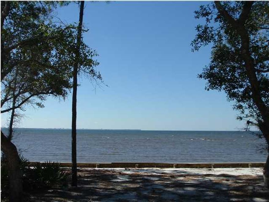 This beautiful Bay Front lot has 80 feet of waterfront with seawall & riprap in place Enjoy breathtaking sun rises and sunsets in this gorgeous waterfront community with wonderful amenities. HOA membership required with architectural review board requiring 2,000 minimum heated & cooled square footage for waterfront homes. Panoramic vistas, executive homes, city water & sewer, street lights, tennis courts, rv/boat storage,1.75 acre nature preserve, no build out time. This subdivision is a quiet treasure, come make your discovery, fall in love and build your dream. Sellers are licensed Florida Real Estate Agents. All dimensions are approximate and are to be verified to Buyers satisfaction.