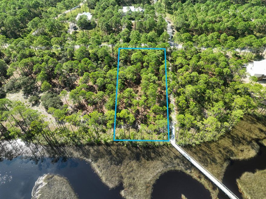 PRICE CHANGE! Come build your dream home on a premier lot in RiverCamps. This beautiful lot backs up to water views of Crooked Creek and is one of the deepest lots in the community giving you an abundance of privacy. Mature oak trees dot the landscape and is within easy walking distance to a soon to be renovated pool and amenities. Lot includes home plans and topographical survey, and lot survey.Rivercamps Crooked Creek offers gated access into the community. Amenities include boat storage, boat dock, boat launch, washout areas, public washrooms, walking trails, campfire/glamping tents. Come be a part of Panama City Beaches fasting growing area that is conveniently, a new hospital, beaches and Pier Park.