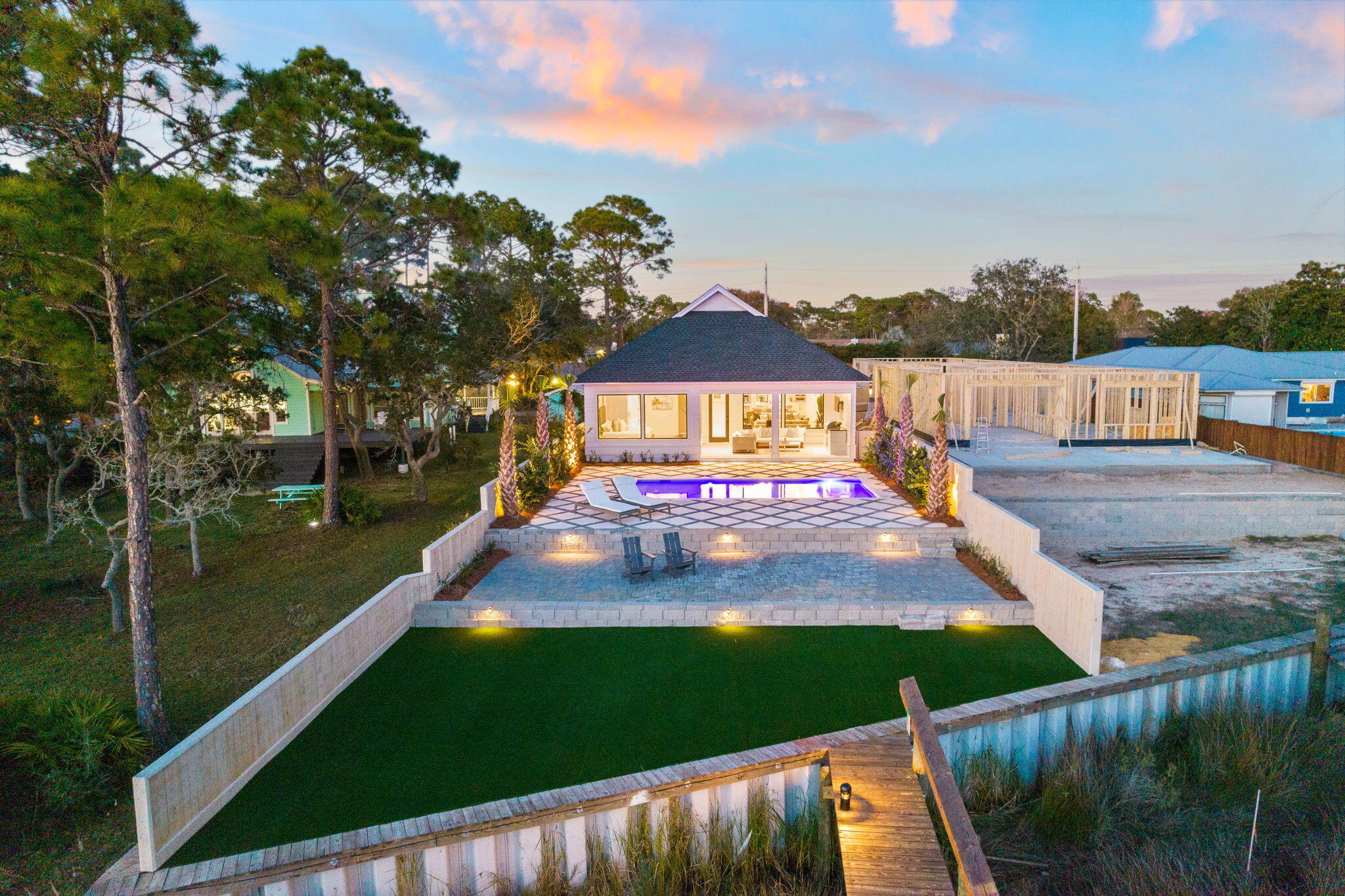 Live the waterfront Florida lifestyle that many dream of experiencing and enjoy a lucrative investment opportunity with this immaculate New Construction Waterfront home located at 8747 N Lagoon Dr. Boasting rental projections of $150,000-$170,000, this home is sure to exceed your expectations. From the moment you step into this stunning home, you will be blown away by the large open floor plan and architectural design that captures natural light and brings the outdoors in beautifully.All of the living spaces have been thoughtfully designed with attention to detail, including the best and finest materials, such as soaring 20ft ceilings in the main living area, hardwood flooring, a neutral color palette, and designer lighting. An entertainer's paradise, the stunning